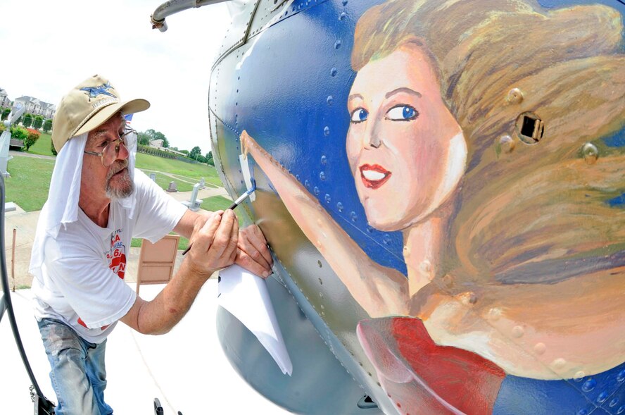 BARKSDALE AIR FORCE BASE, La. -- Ron Fountain, Houston’s Southwest Museum Services development director, carefully paints "Miss Liberty" on the nose of a B-17G at the Eighth Air Force museum May 18. The near-complete paint job mirrors a B-17G that was flown by Maj. Gen. Lewis E. Lyle, who flew many missions in B-17s during World War II. (U.S. Air Force photo/Staff Sgt. John Gordinier)