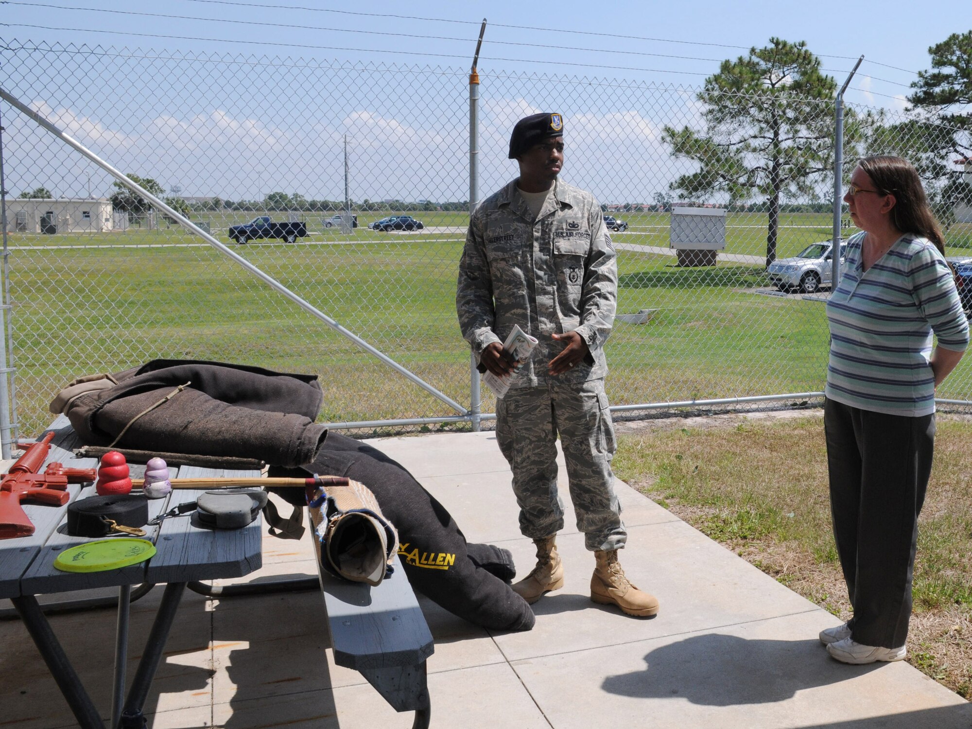 Donna LaRue, a member of the Military Working Dog Team Support Association, listens as Staff Sgt. Reginald Overstreet, a trainer for the 6th Security Forces Squadron Military Working Dog section, explains the different equipment used to train the military working dogs at MacDill Air Force Base, Fla. May 21, 2010. The 6th SFS/MWD section works with 11 dogs, three of which are currently deployed. (U.S. Air Force photo by Senior Airman Anna-Marie Wyant)