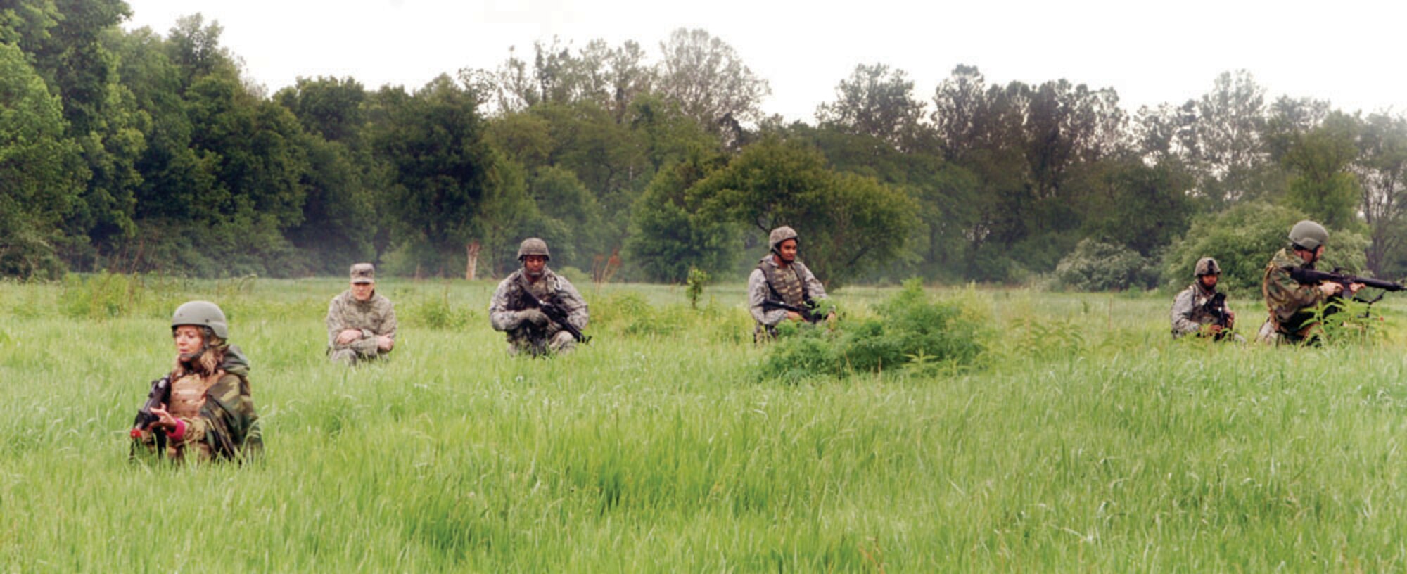 Local community leaders and members of the 88th Air Base Wing Security Forces Squadron walk through tall grass for their daytime patrol as Col. Richard J. Hazdra, 88th ABW vice commander, looks on during Operation Community Warfighter here May 17-18. 