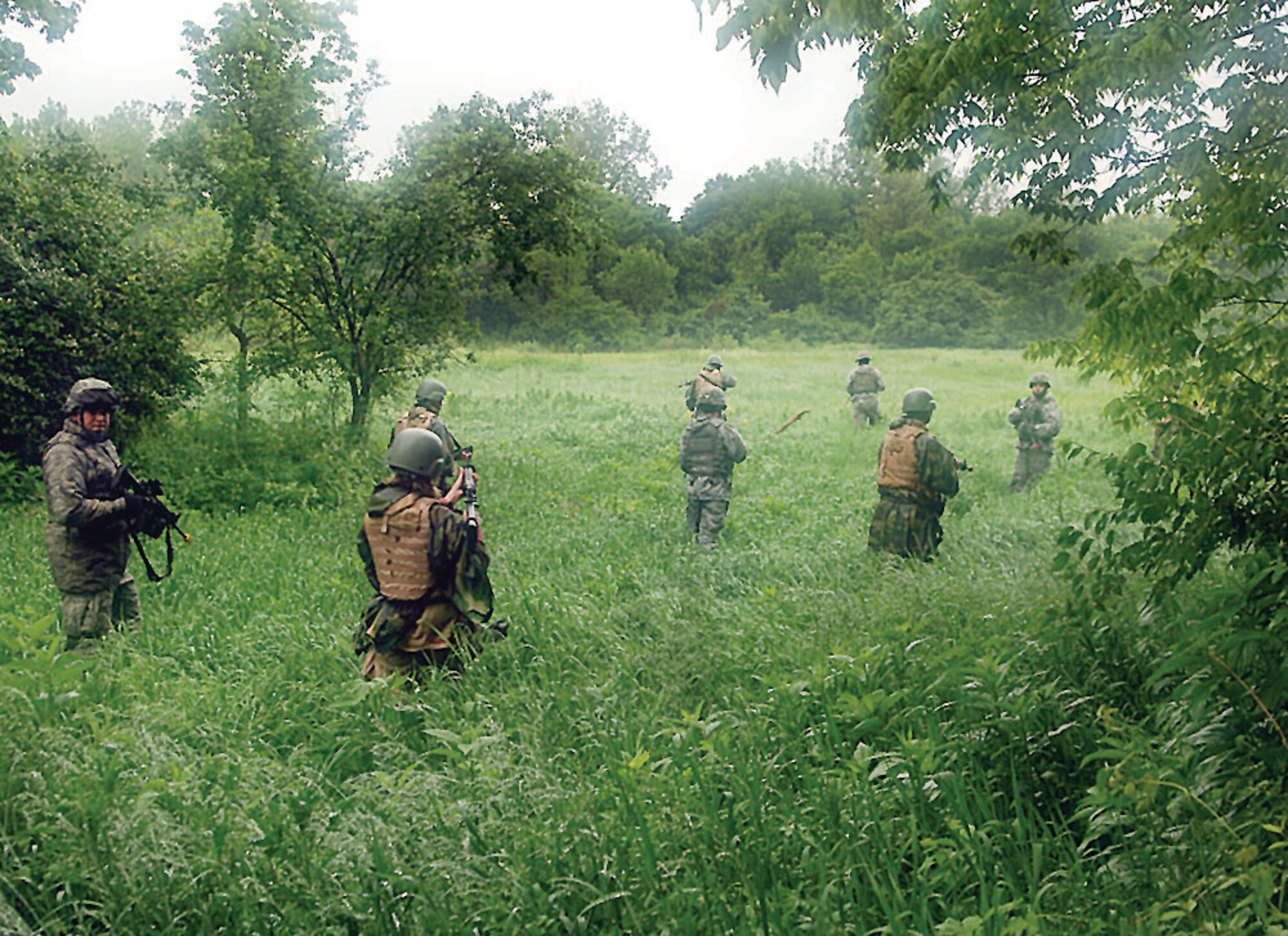 Local community leaders and members of the 88th Air Base Wing Security Forces Squadron head out into tall grass for their daytime patrol during Operation Community Warfighter here May 17 - 18. 