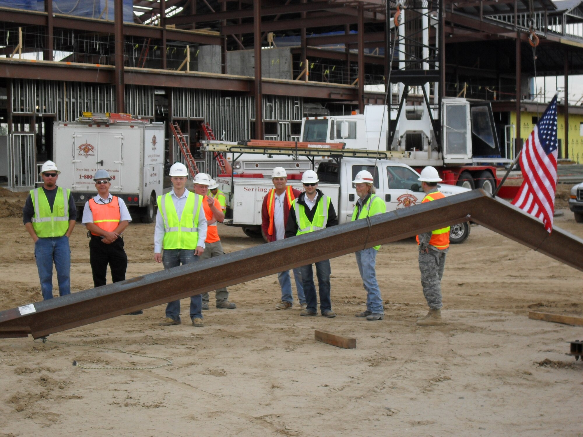 Workers prepare to place the last major piece of steel on the new Air Reserve Personnel Center building being constructed on Buckley Air Force Base May 18. ARPC is expected to move from the former Lowry AFB to Buckley in 2011. (U.S. Air Force photo)
