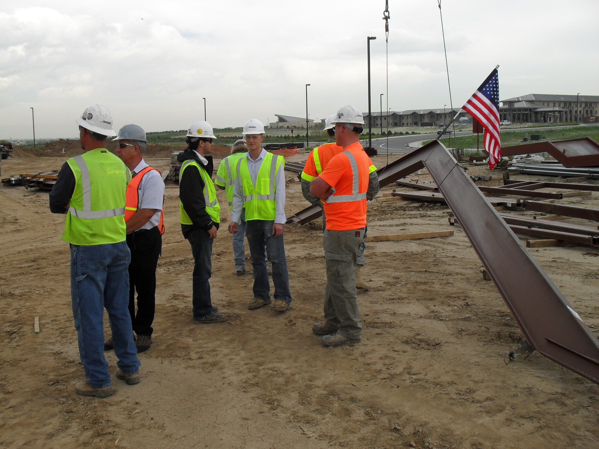 Workers prepare to place the last major piece of steel on the new Air Reserve Personnel Center building being constructed on Buckley Air Force Base May 18. ARPC is expected to move from the former Lowry AFB to Buckley in 2011. (U.S. Air Force photo)