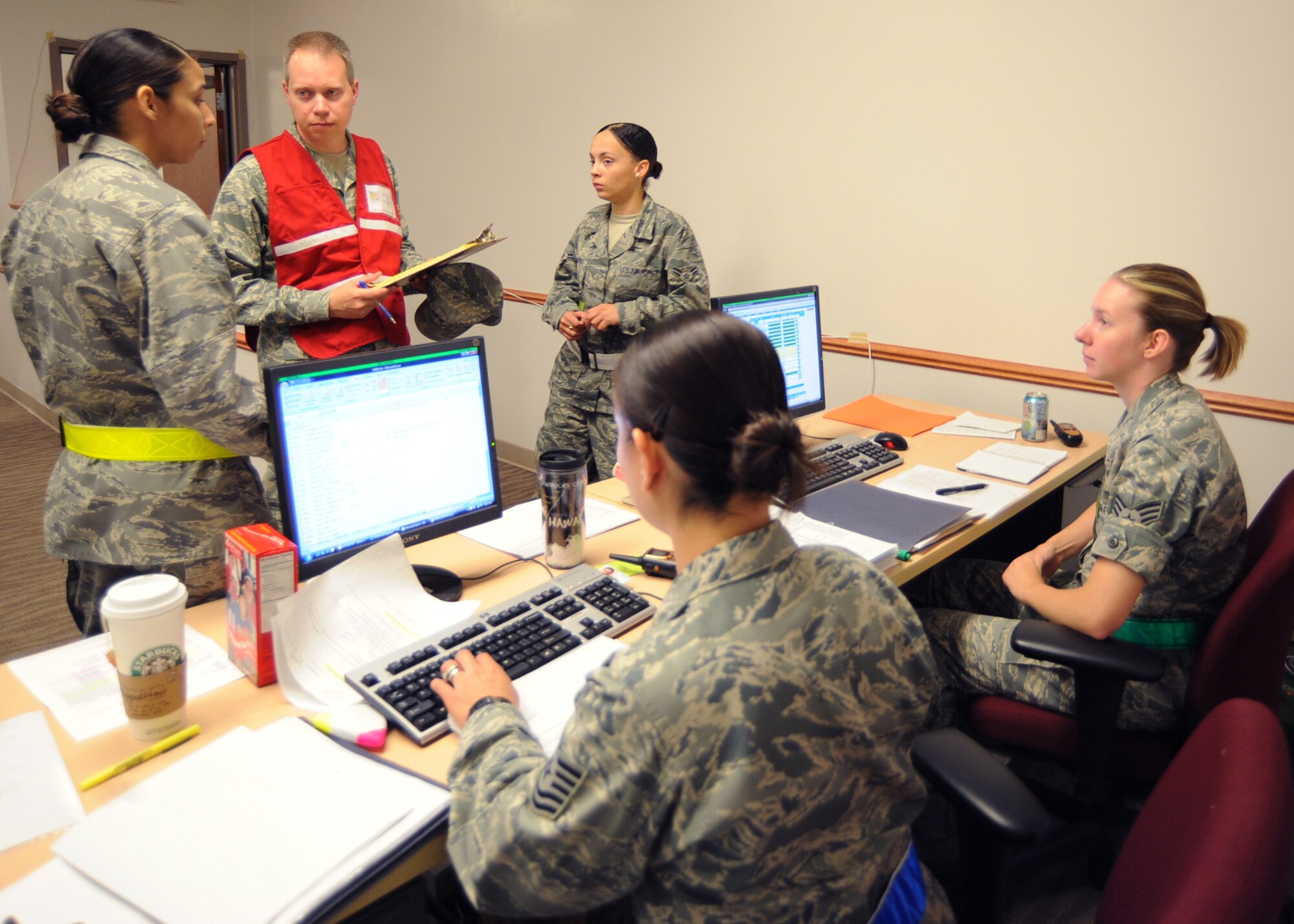 Capt. Douglas Crow, 931st Air Refueling Group Exercise Evaluation Team chief, asks the communications point of the personnel deployment function line about information regarding PDF processes during an operational readiness exercise May 19, 2010, McConnell Air Force Base, Kan. The PDF ensures personnel are properly accounted for and processed before deploying. The ORE will prepare Team McConnell Airmen to mobilize the wing for a short notice deployment. (U.S. Air Force photo/Senior Airman Maria Ruiz)