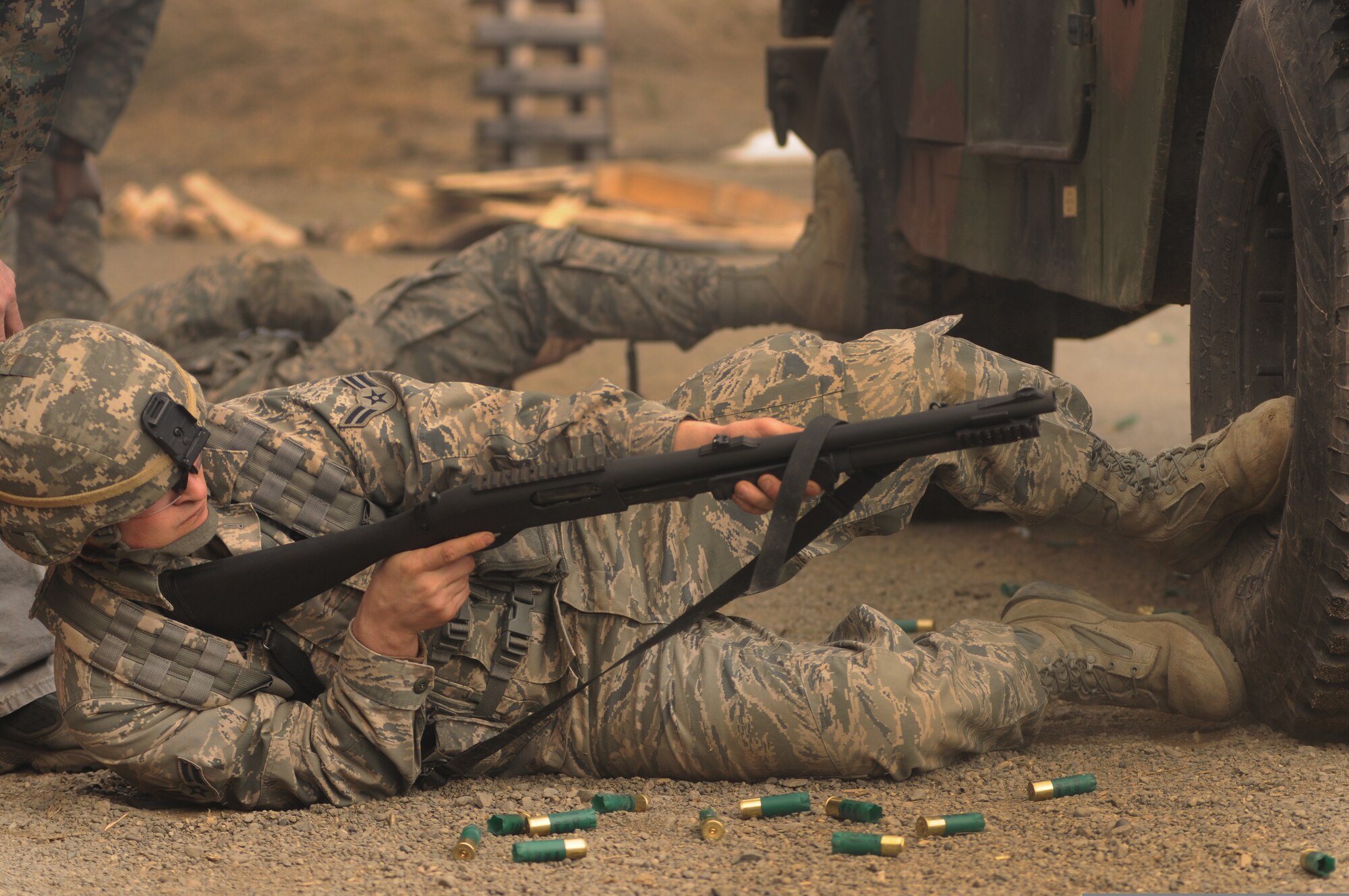 U.S. Air Force Airman 1st Class Matthew Taylor, of the 173rd Security Forces Squadron, Oregon Air National Guard, fires his shotgun while in a defensive position on the small weapons range at Fort Richardson, Alaska, April 28, 2010. Taylor is participating in exercise Vigilant Guard. (U.S. Air Force photo by Tech. Sgt. Brian E. Christiansen/Released)