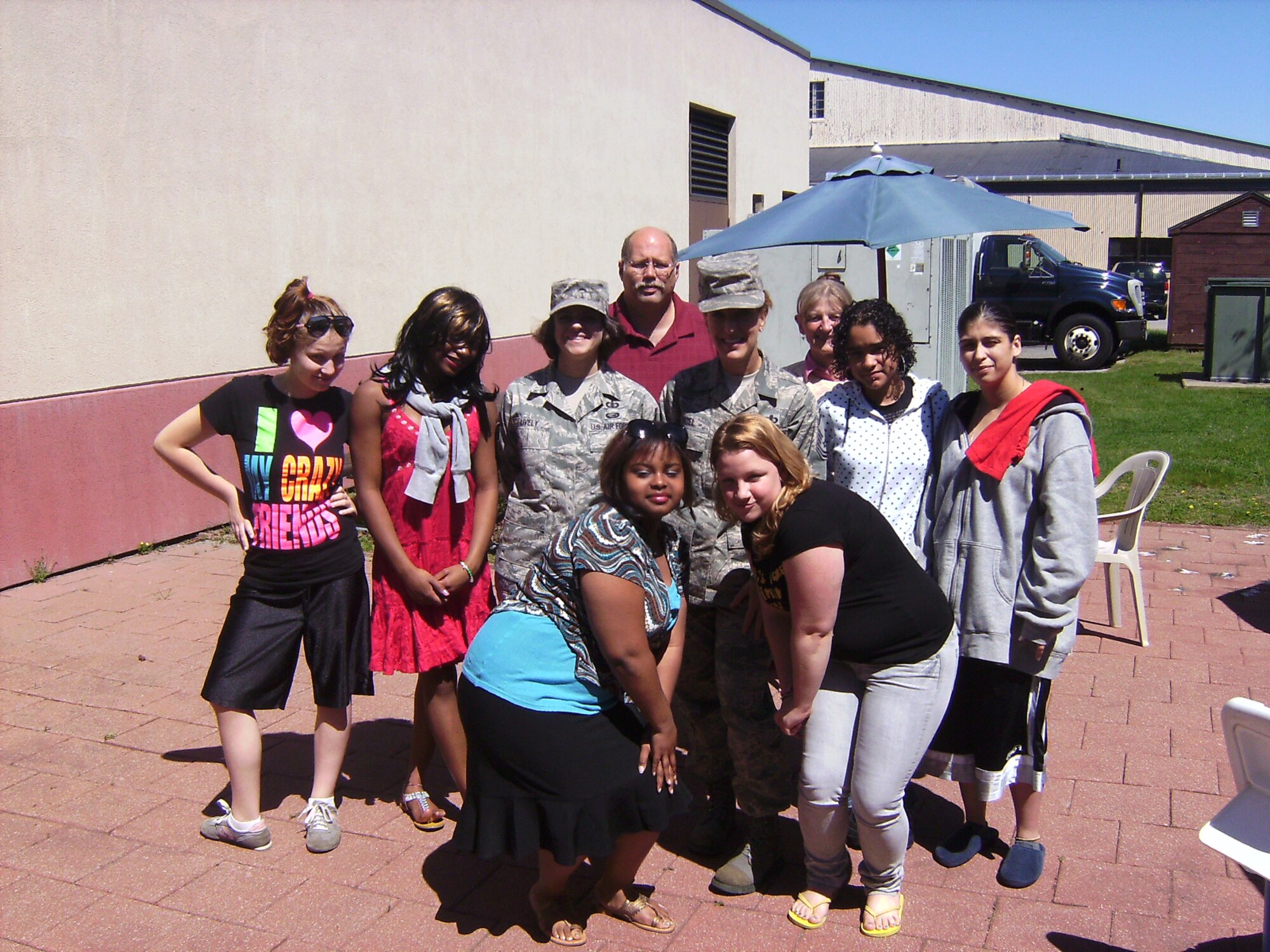 SMSgt Noel, TSgt Lively and Asst. Principal Michael Siplas pose with the select students from the Cottage Hill Academy