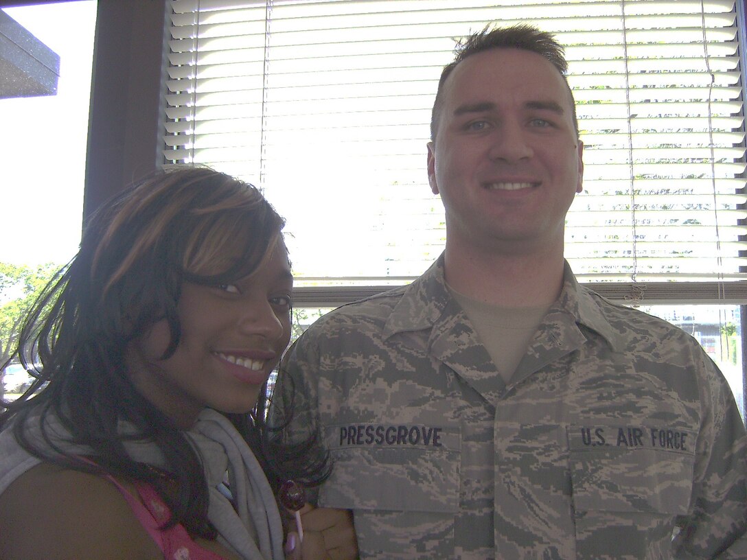A1C William Pressgrove sang a beautiful rendition of "Bring Him Home" for the students during the rehersal.  He is pictured here with one of Cottage Hill's rising young singers.  