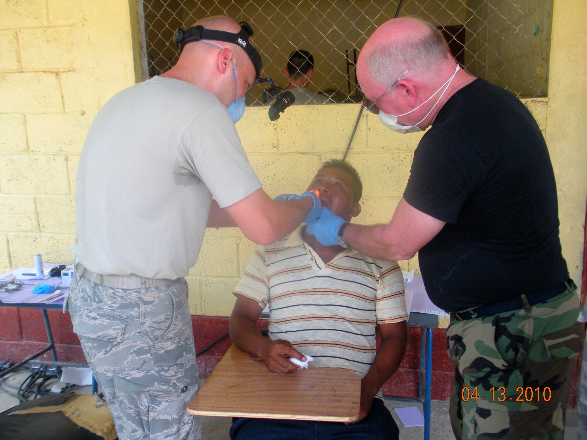 Master Sgt. Neil Neisner, 173rd Medical Group Independent Duty Medical Technician, and Lt. Col. Philip Bales, 173rd MDG Dentist, prepare to remove a tooth from a patient in Puerto Barrios, Guatemala during the Beyond Horizon's exercise April 12, 2010.  Twenty three personnel from the 173rd MDG deployed to Guatemala in support of this exercise which is designed to bring basic medical, dental and optical care to communities in need.   (U.S. Air Force Photo by Unknown)