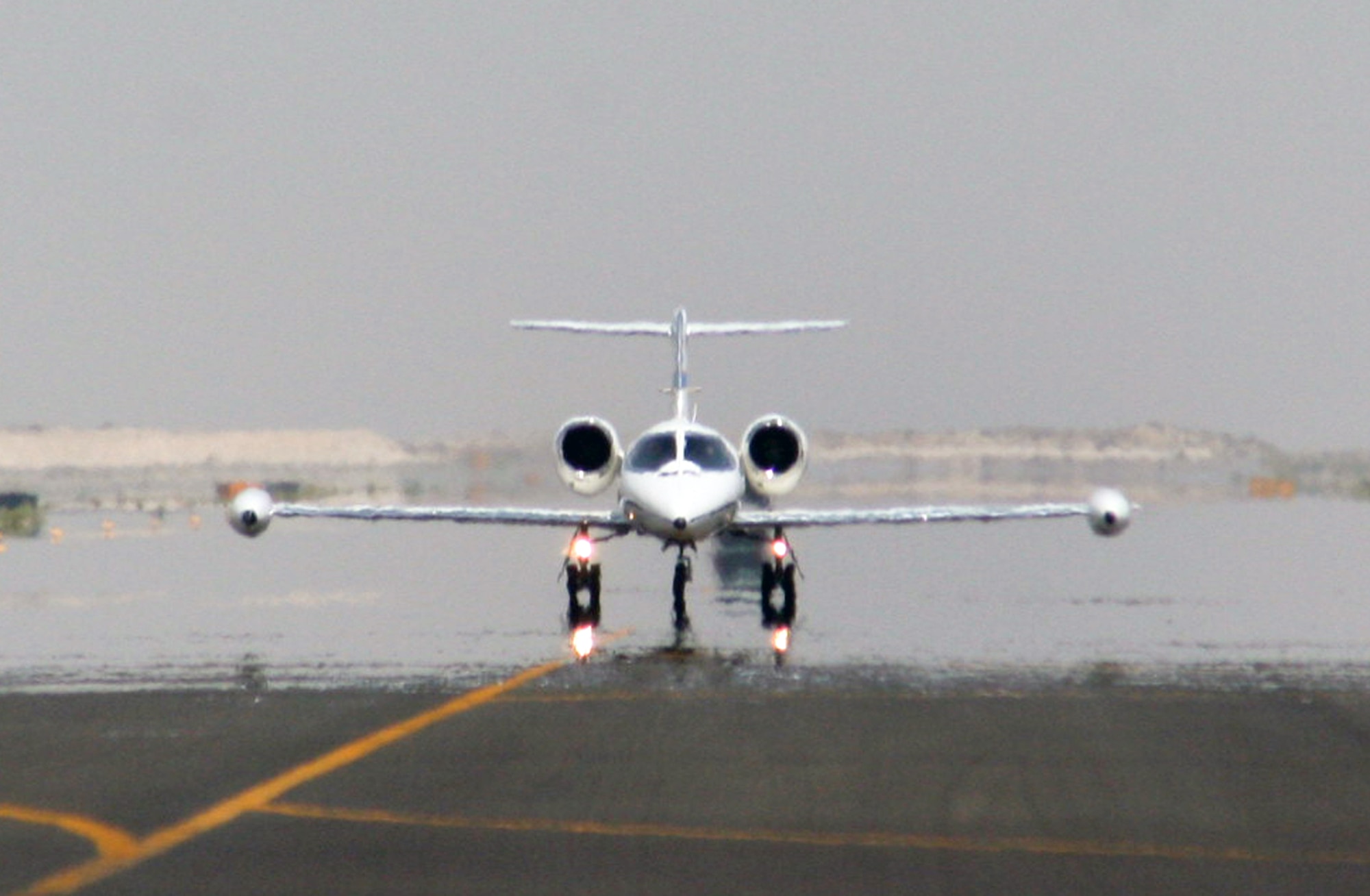 A C-21 passenger jet taxis on the runway to the flightline of the 380th Air Expeditionary Wing at a non-disclosed location in Southwest Asia on May 19, 2010.  The C-21, according to its Air Force fact sheet, is a twin turbofan engine aircraft used for cargo and passenger airlift. The aircraft is the military version of the Lear Jet 35A business jet. In addition to providing cargo and passenger airlift, the aircraft is capable of transporting one litter or five ambulatory patients during aeromedical evacuations. The C-21 can carry eight passengers and 42 cubic feet (1.26 cubic meters) of cargo. (U.S. Air Force Photo/Master Sgt. Scott T. Sturkol/Released)
