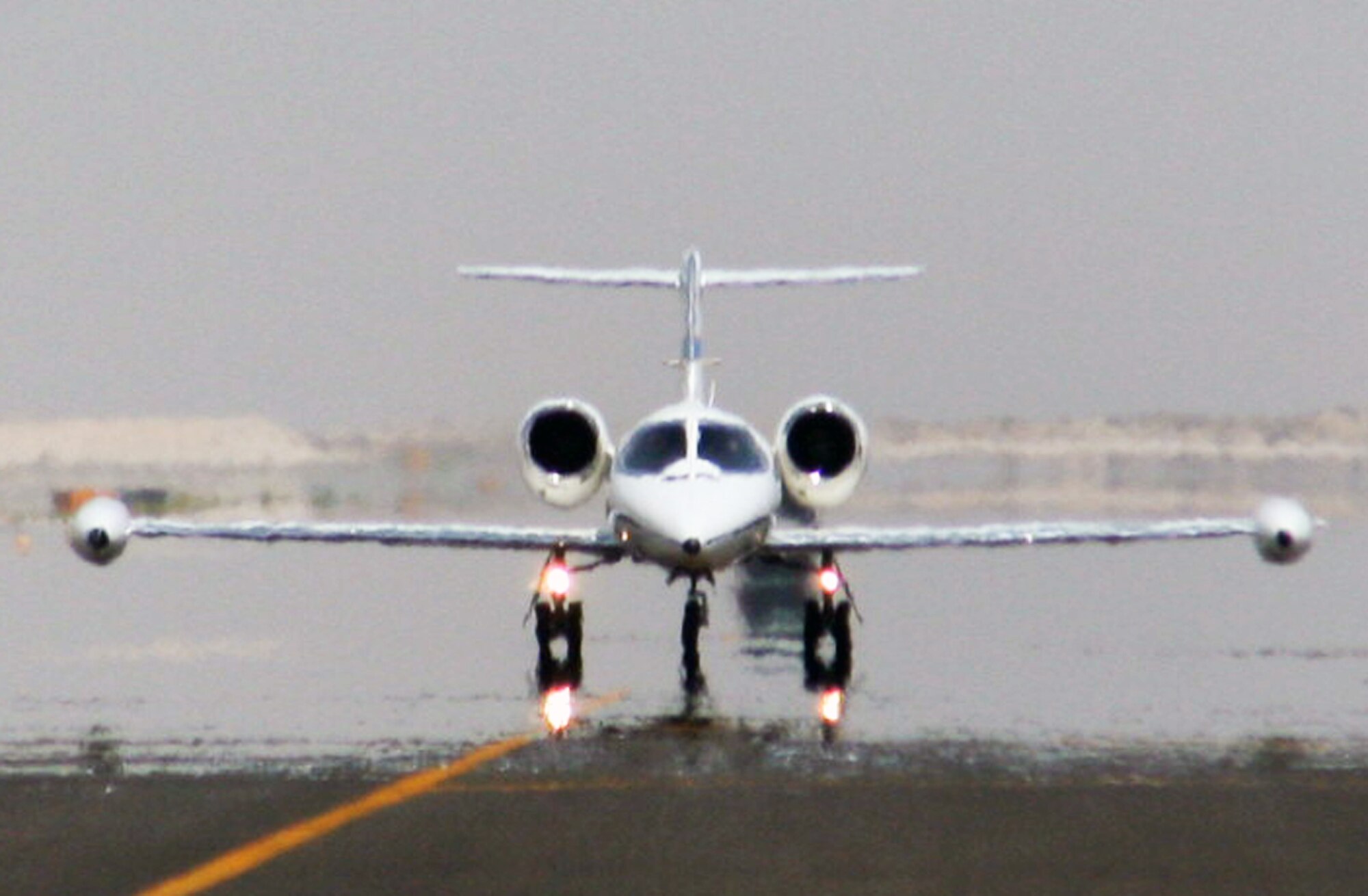 A C-21 passenger jet taxis on the runway to the flightline of the 380th Air Expeditionary Wing at a non-disclosed location in Southwest Asia on May 19, 2010.  The C-21, according to its Air Force fact sheet, is a twin turbofan engine aircraft used for cargo and passenger airlift. The aircraft is the military version of the Lear Jet 35A business jet. In addition to providing cargo and passenger airlift, the aircraft is capable of transporting one litter or five ambulatory patients during aeromedical evacuations. The C-21 can carry eight passengers and 42 cubic feet (1.26 cubic meters) of cargo. (U.S. Air Force Photo/Master Sgt. Scott T. Sturkol/Released)