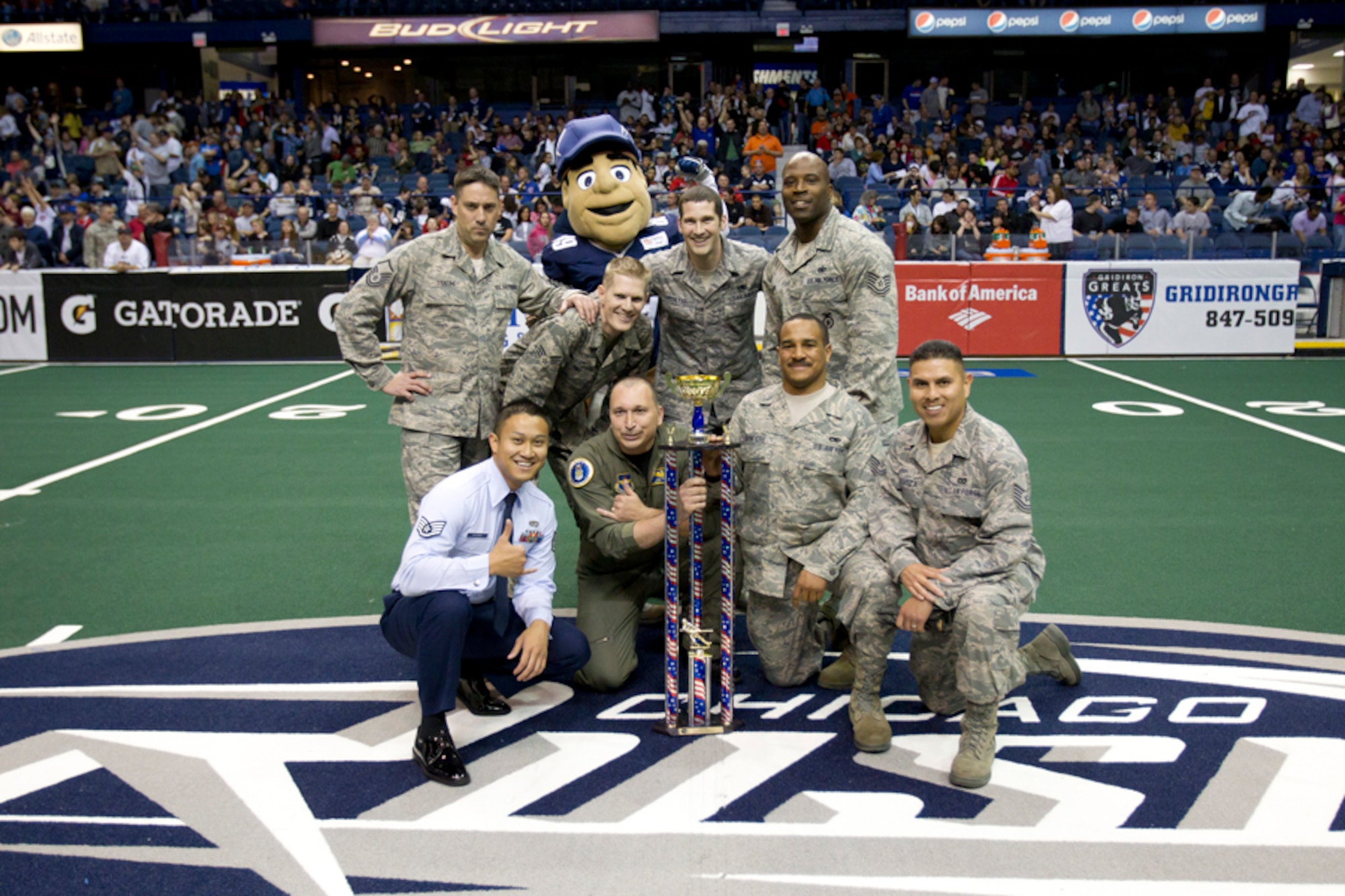 The 347th Recruiting Squadron's Chicago-area recruiters beat Army and Navy squads at halftime in front of 10,000 arena league football fans on Armed Forces Day May 15. Airmen posing with the Heroes Cup and Chicago Rush mascot are, left to right: kneeling, Staff Sgt. Johnson Xaysana, Master Sgt. Joey Minor, Tech. Sgt. Sean Sawyers, Tech. Sgt. Mario Cardoza; standing, Master Sgt. Chris Van Tine, Senior Airman Cedric Hill, Staff Sgt. Shaun McGlynn and Tech. Sgt. Al Lomax. (U.S. Air Force photo)