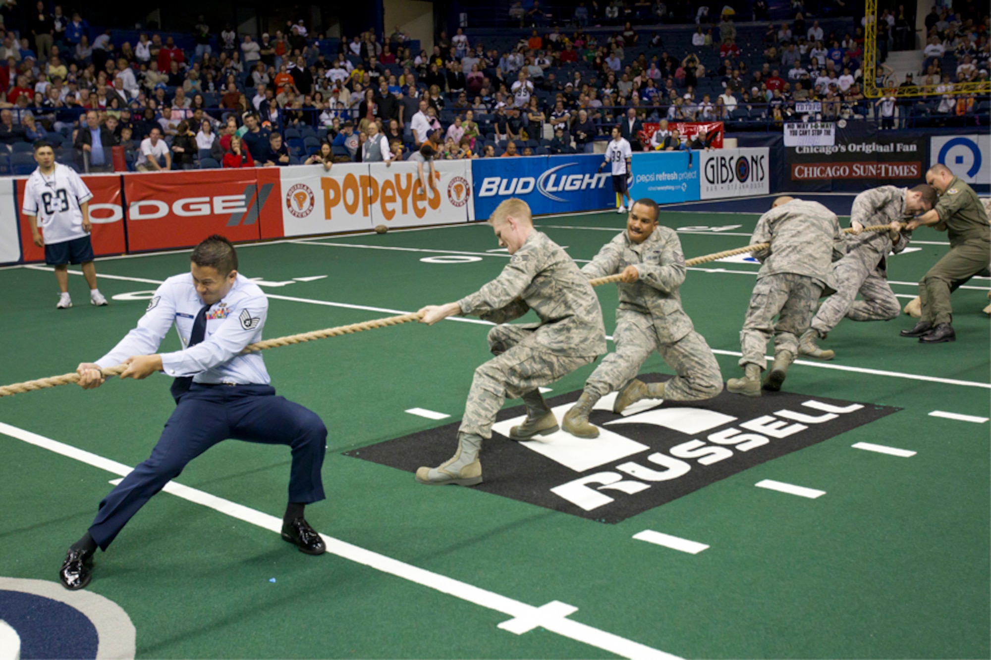 A team of Chicago-area 347th Recruiting Squadron recruiters took home the trophy on Armed Forces Day May 15 in front of 10,000 Chicago Rush arena league football fans. The Air Force team beat Army and Navy at a tug of war to earn the inaugural Chicago Rush Heroes Cup. The Chicago Rush invited all services to be their guests at the Armed Forces Day game against the Iowa Barnstormers. (U.S. Air Force photo)