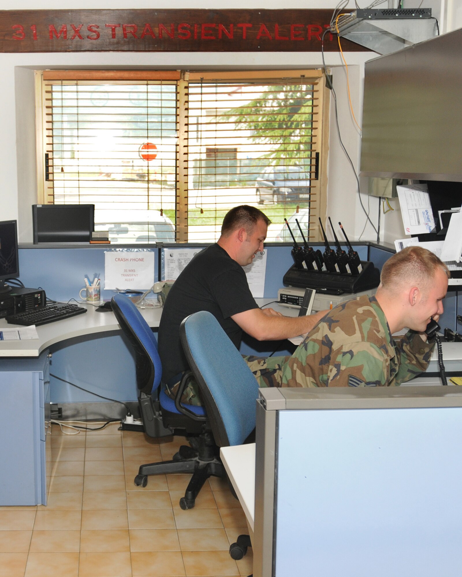 Senior Airman Nicholas Nelson and Staff Sgt.Ryan Kulver, 31st Maintenance Squadron Transit Alert crew chiefs, schedule aircraft ground equipment for incoming aircraft. The TA shop no assigned to Aviano, these aircraft include NATO forces, rotators taking Airmen to and from various locations, C-130 Hercules used to support joint exercises, and those belonging to friendly foreign nations. (U.S. Air Force photo/ Senior Airman Tabitha Mans)