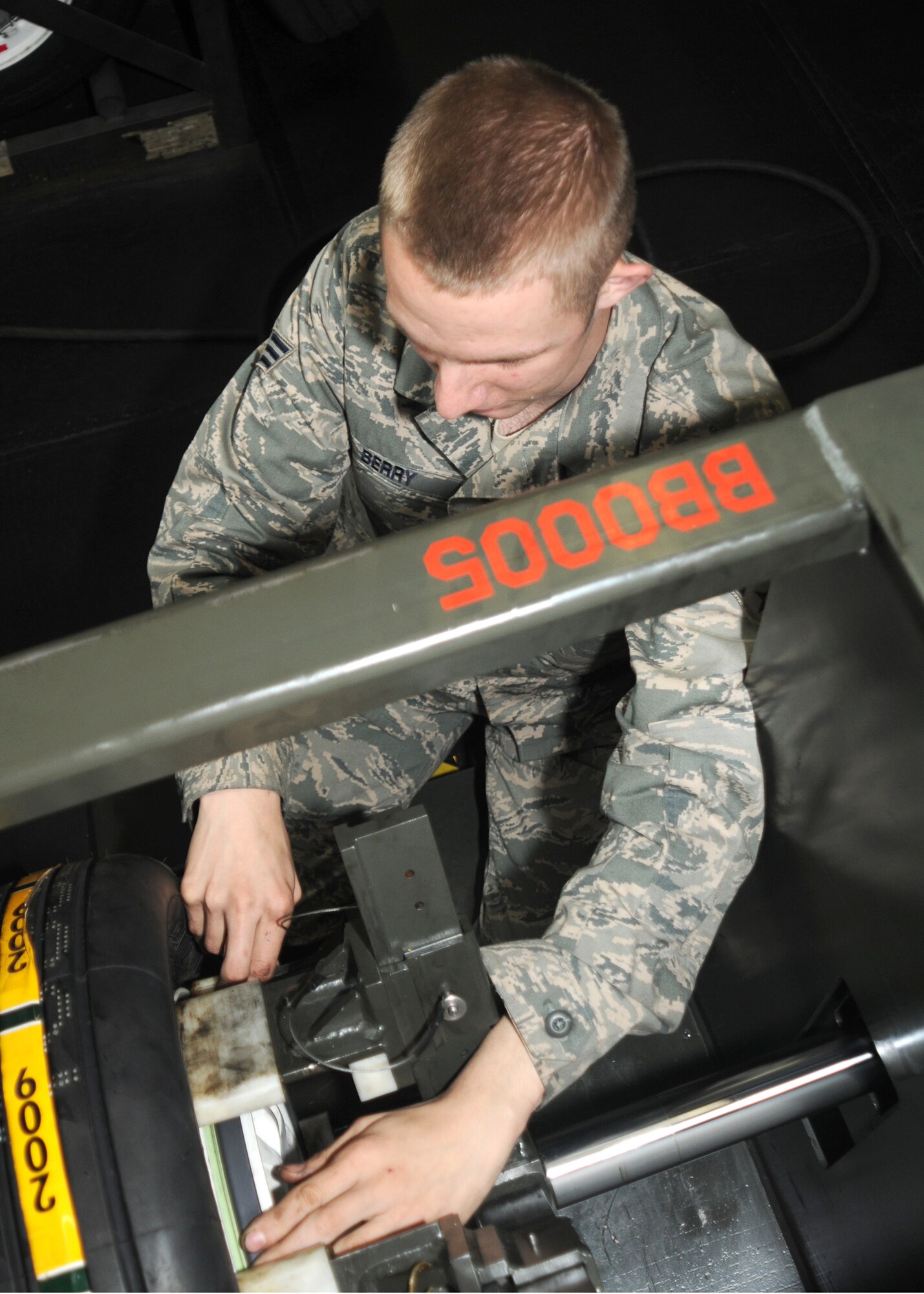 Senior Airman Christopher Berry, 31st Maintenance Squadron Transit Alert crew chief, replaces a lock ring on a main landing gear wheel at Hangar 1. (U.S. Air Force photo/ Senior Airman Tabitha Mans)