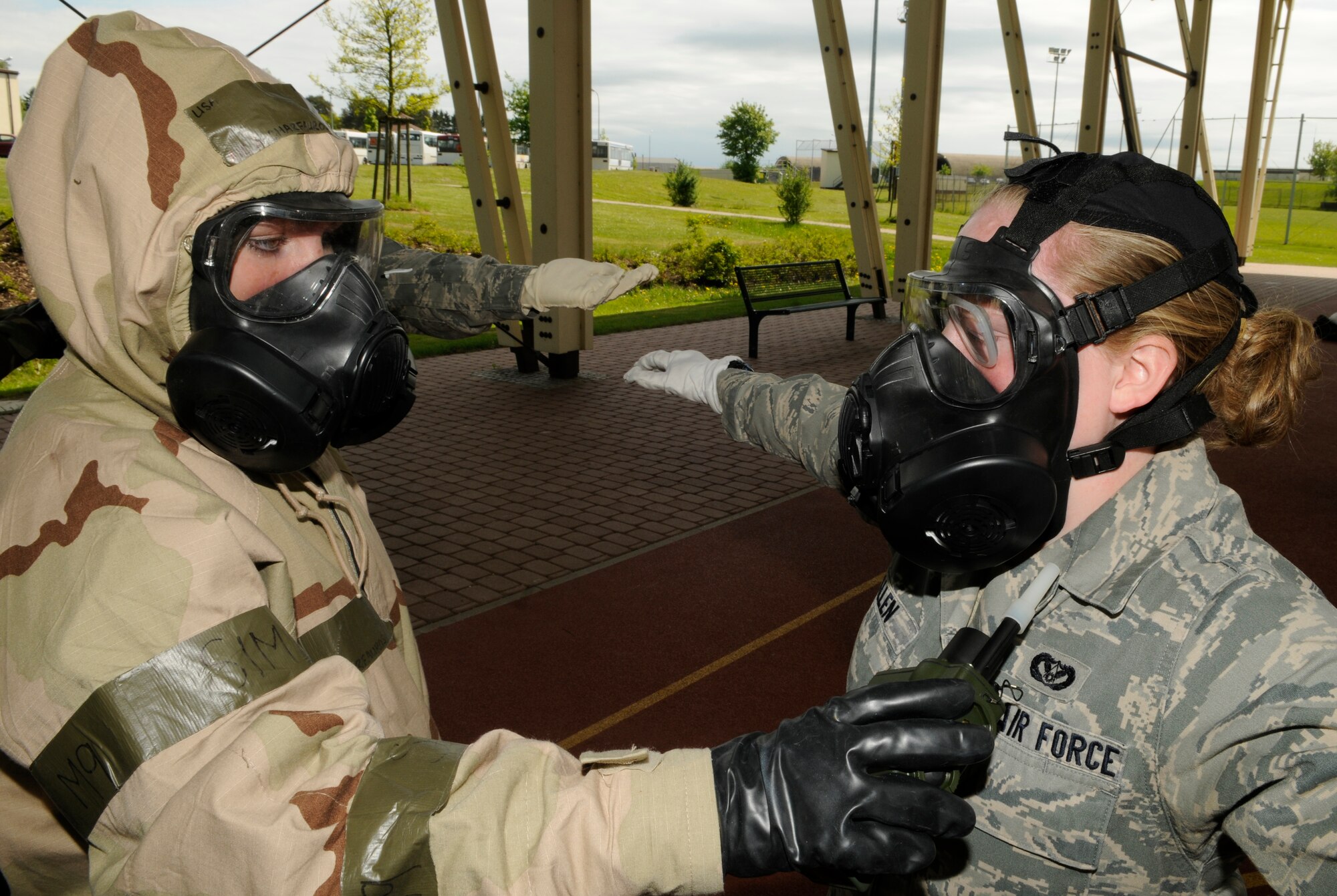 SPANGDAHLEM AIR BASE, Germany – Airman 1st Class Ashley Charfauros, 52nd Civil Engineer Squadron, uses a joint chemical agent detector to check for chemical contamination on Airman 1st Class Jennea Allen, 52nd CES, before allowing her to leave a contamination control area May 20. The CCA was set up for a one-day exercise in preparation for the NATO Force Evaluation. (U.S. Air Force photo/Senior Airman Benjamin Wilson)