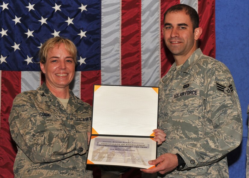 United States Air Force Colonel Michele Cook, Chief, Intelligence and Knowledge Development Directorate-Molesworth presents United States Air Force Senior Airman Manuel Minjarez with a certificate signed by Unites States Air Force Major General Michael A. Snodgrass for winning the 2010 U.S. Africa Command Air Force Airman of the Year.   (Photo by Air Force Staff Sgt. Javier Cruz)