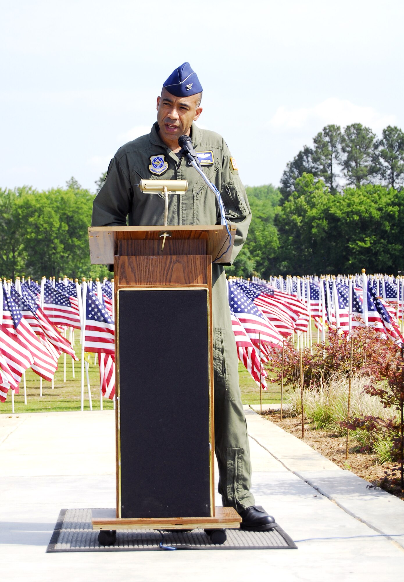 Col. James Johnson, 43rd Airlift Wing Commander, speaks at the Glory Days Field of Honor event at the Airborne Special Operations Museum. During the event, a flag was placed in honor of Senior Airman Ashton Goodman, who was assigned to Pope’s 43rd Logistics Readiness Squadron. (U.S. Air Force photo/2nd Lt. Cammie Quinn)