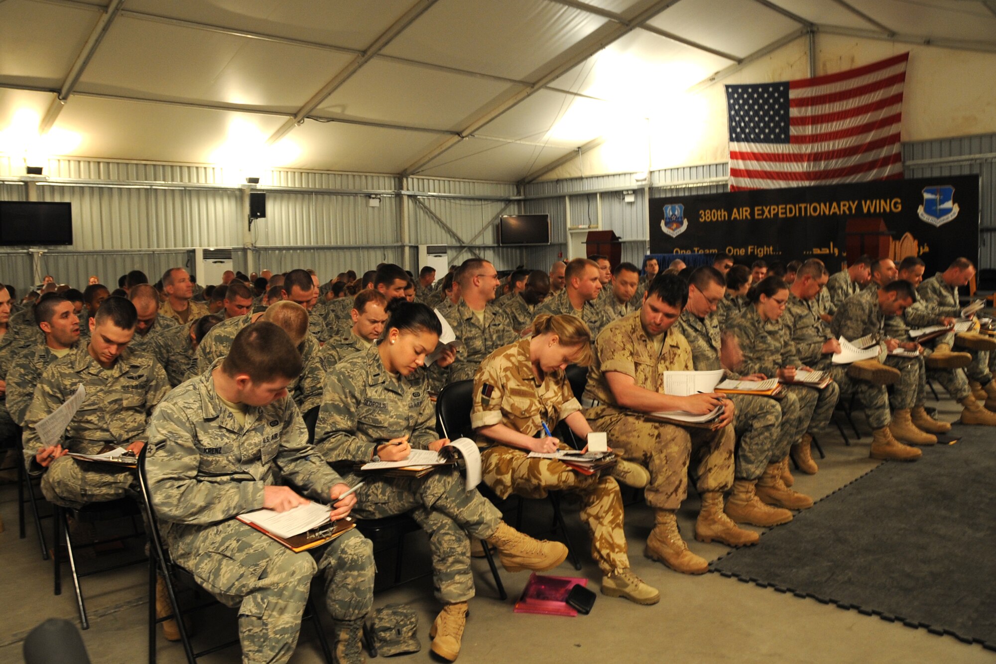 New Airmen of the 380th Air Expeditionary Wing in-process and attend briefings  at an undisclosed location in Southwest Asia on May 8, 2010.The 380th AEW supports Operations Iraqi Freedom and Enduring Freedom and the Combined Joint Task Force-Horn of Africa. Its comprised of four groups and 12 squadrons. The wing's deployed mission includes air refueling, surveillance and reconnaissance in support of overseas contingency operations in Southwest Asia.(U.S. Air Force photo/Senior Airman Jenifer H. Calhoun/Released)