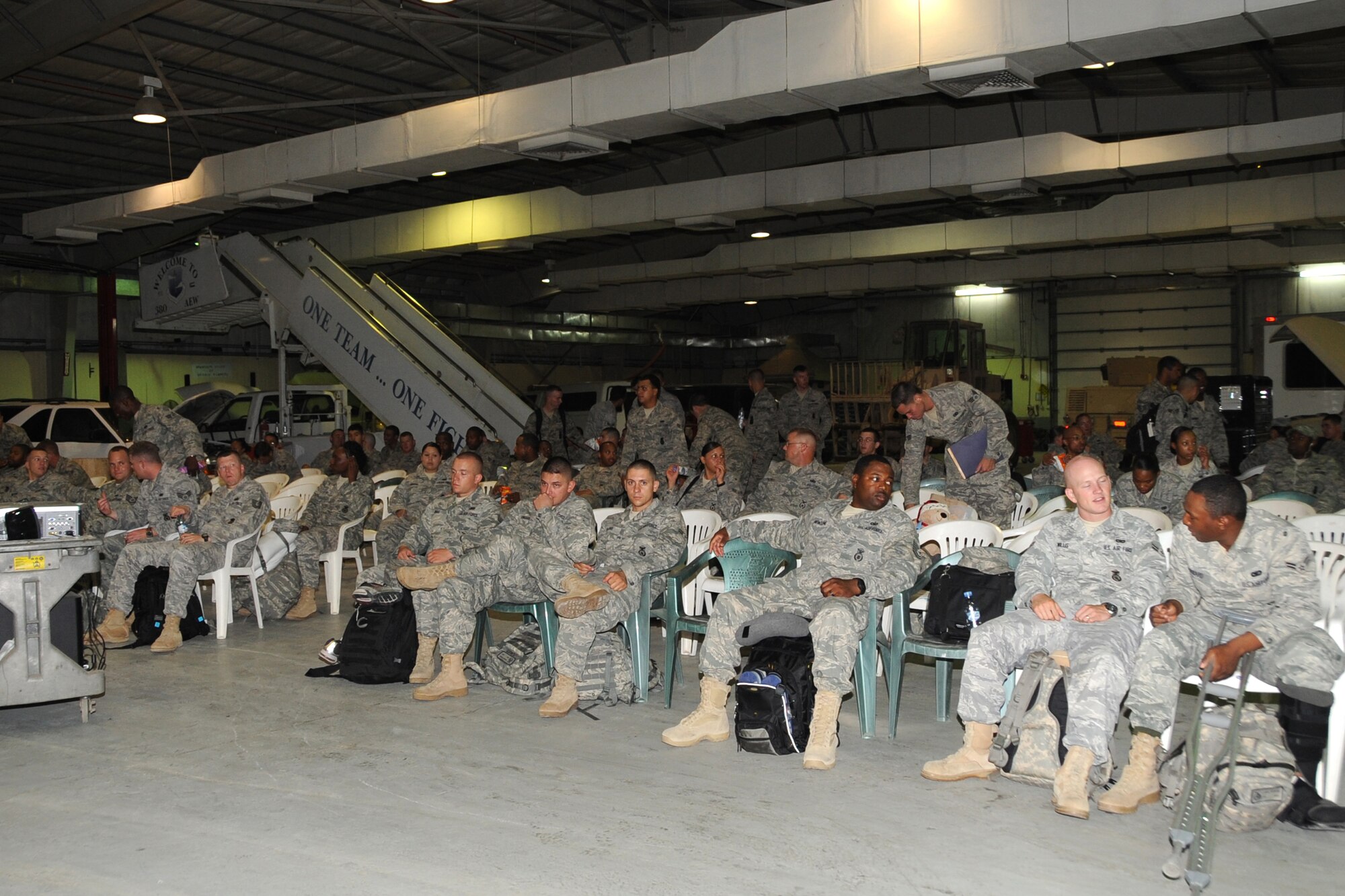 Members of the 380th Air Expeditionary Wing await departure from an undisclosed base in Southwest Asia, after completing their deployment here May 8, 2010. Due to the high numbers of incoming and out- going personnel, the 380th Expeditionary Logistics Readiness Squadron modified the vehicle maintenance shop into a temporary holding area for outgoing Airmen. The 380th AEW supports Operations Iraqi Freedom and Enduring Freedom and the Combined Joint Task Force-Horn of Africa. Its comprised of four groups and 12 squadrons.  The wing's deployed mission includes air refueling, surveillance and reconnaissance in support of overseas contingency operations in Southwest Asia.(U.S. Air Force photo/Senior Airman Jenifer H. Calhoun/Released)