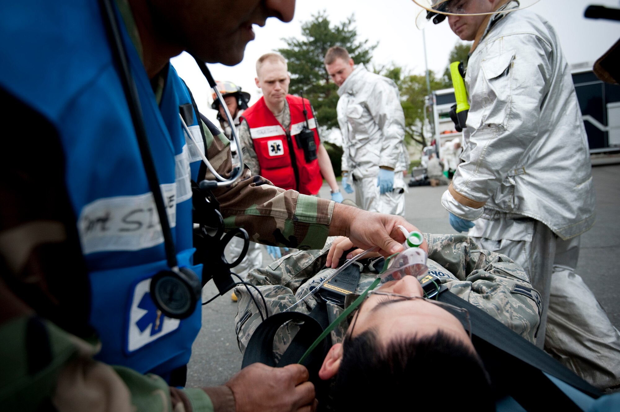 MISAWA AIR BASE, Japan -- Maj. Zahid Siddique, 35th Aerospace Medical Squadron immediate response team alternate chief, places an oxygen mask on a simulated victim during an emergency response exercise at the Richard Bong Theater May 19. The exercise gave medical responders a chance to practice medical casualties during an emergency situation. (U.S. Air Force photo/Staff Sgt. Samuel Morse)