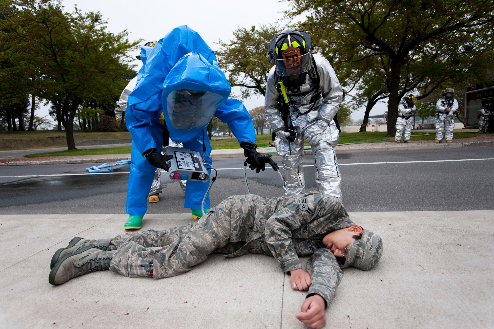 MISAWA AIR BASE, Japan -- Airman 1st Class Donary Scully, 35th Aerospace Medical Squadron bio-environmental technician, tests for contaminants on a simulated blast victim during an emergency management exercise at the Richard Bong Theater May 19. Emergency responders practiced extracting victims from a contaminated area which prepared them in the event of a real-world biological or chemical attack. (U.S. Air Force photo/Staff Sgt. Samuel Morse)