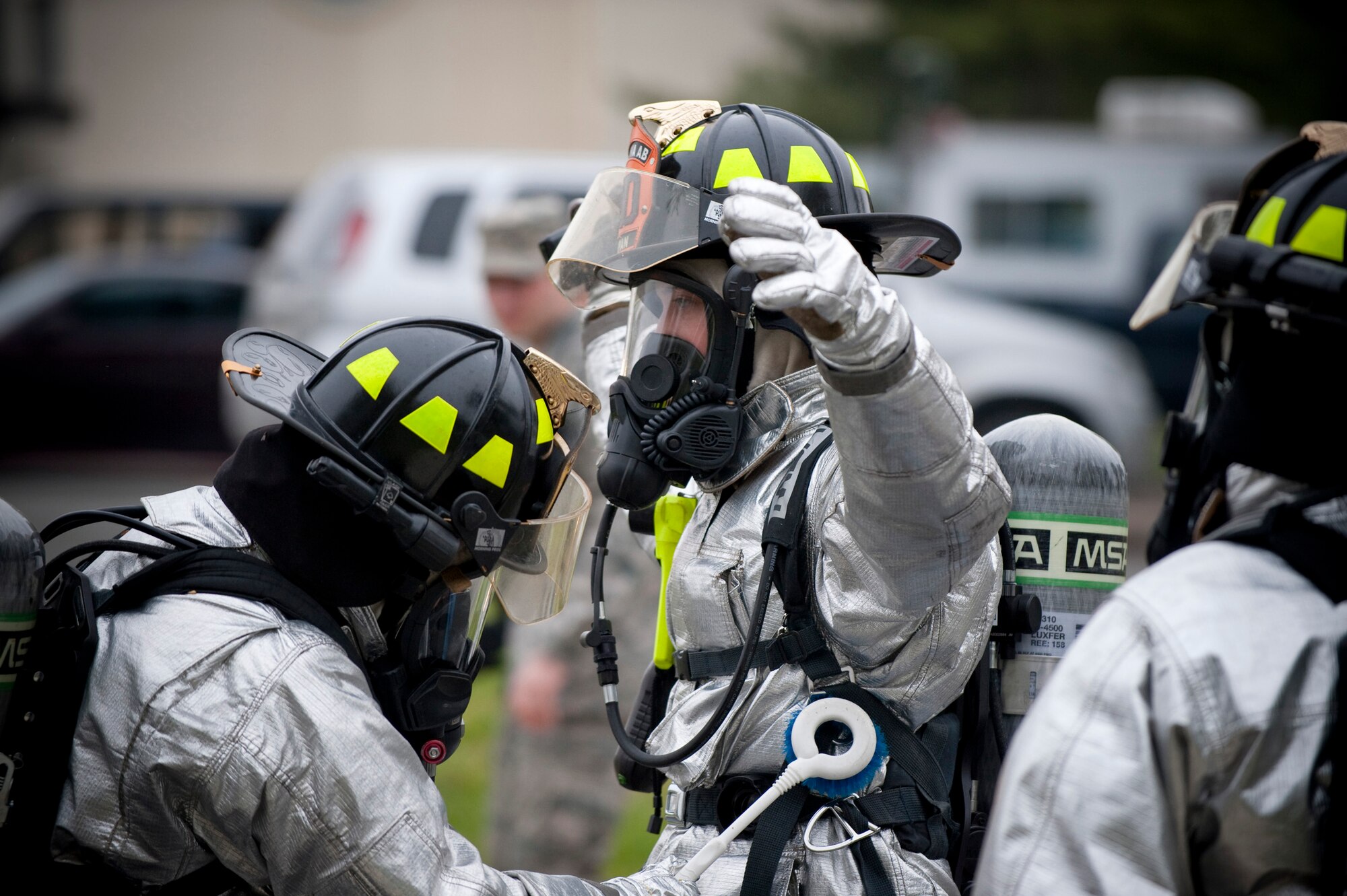 MISAWA AIR BASE, Japan -- A firefighter from the 35th Civil Engineer Squadron receives a simulated decontamination scrub-down during an emergency management exercise at the Richard Bong Theater May 19. The exercise simulated a terrorist explosion involving toxic chemicals. (U.S. Air Force photo/Staff Sgt. Samuel Morse)