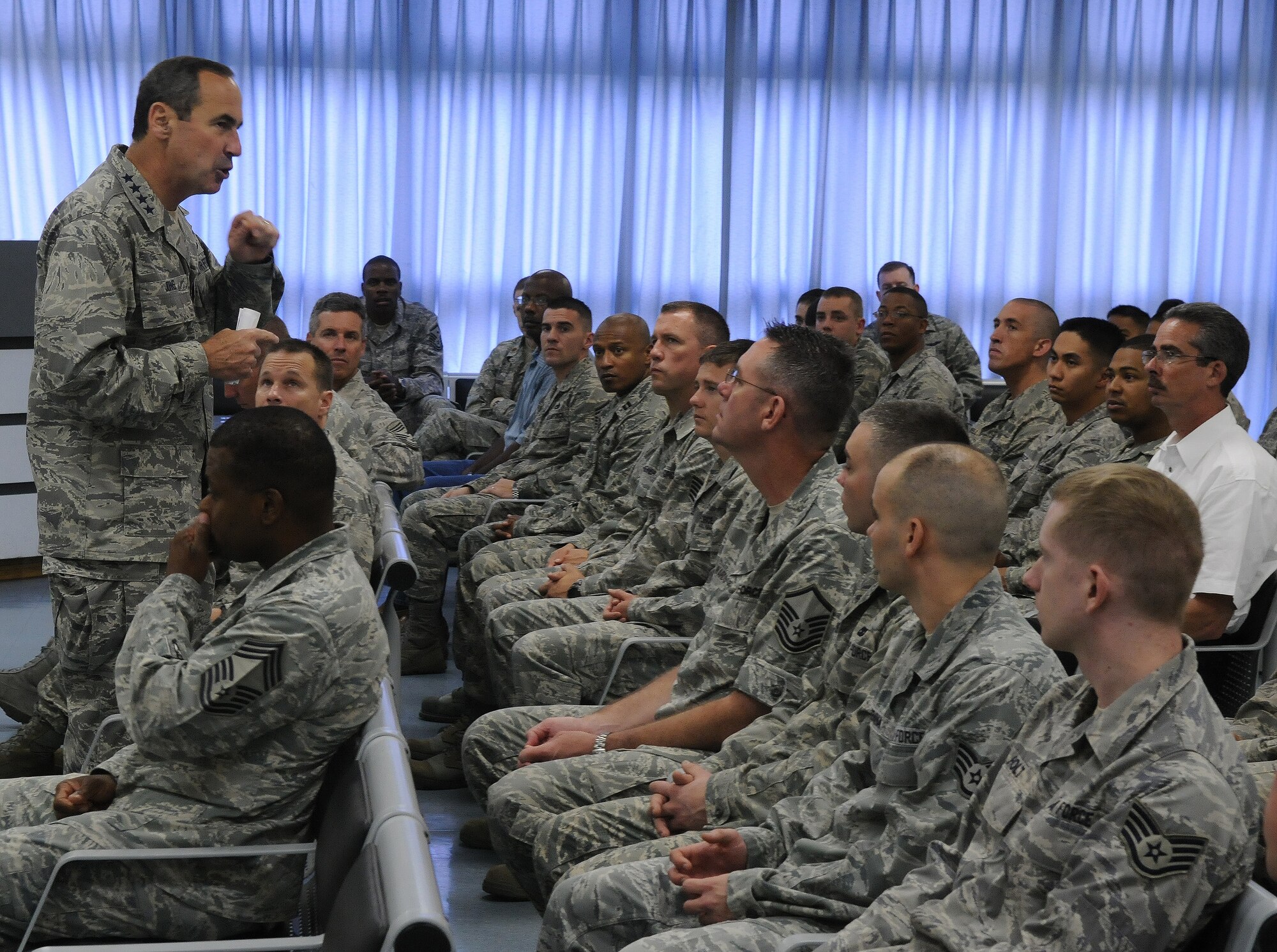 Gen. Raymond Johns, Air Mobility Command commander, talks with 733rd Air Mobility Squadron Airmen and civilian workers during a commander's call here May 15. General Johns visited Kadena’s tenant unit as part of his initial theater-wide orientation of Pacific units since he took command in November 2009. (U.S. Air Force photo by Senior Airman Amanda Grabiec)