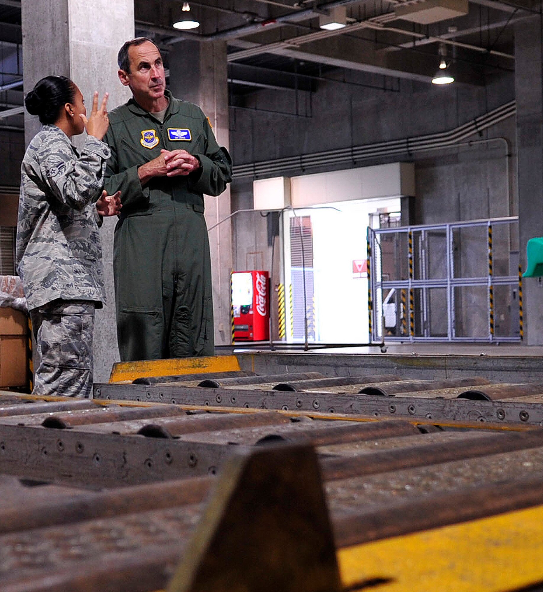 Airman 1st Class Erica Jones, a 733rd Air Mobility Squadron aircraft services specialist, briefs Gen. Raymond Johns, Air Mobility Command commander, May 14 about a new cargo loading system at the squadron here. General Johns visited Kadena’s tenant unit as part of his initial theater-wide orientation of Pacific units since he took command in November 2009. (U.S. Air Force photo by Senior Airman Amanda Grabiec)