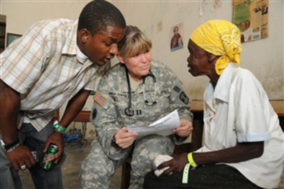 U.S. Army Capt. Leslie Snowden-Crawford (2nd from right), a nurse with 94th Combat Support Hospital, out of Seagoville, Texas, evaluates an elderly Haitian woman during a medical readiness training exercise in Couteaux, Haiti, on Apr. 30, 2010.  The exercise allows U.S. and Haitian medical care providers to offer free level-one medical care to Haitians in the community during Operation Unified Response.  