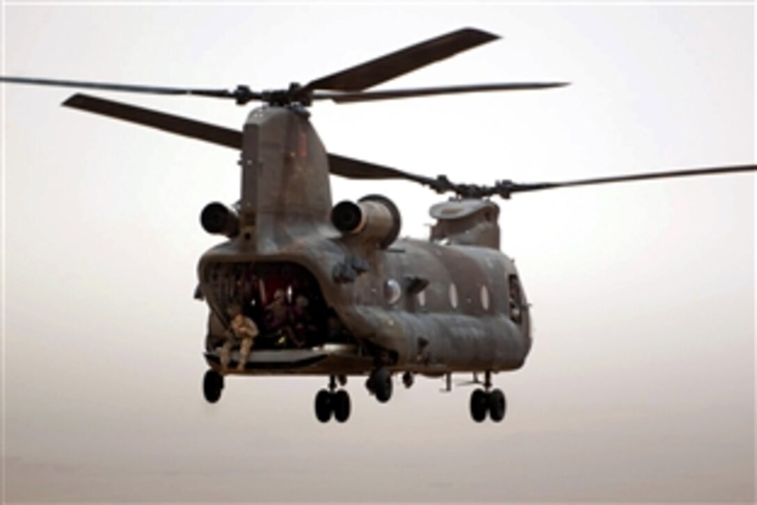A CH-47 Chinook helicopter leaves Al Asad Air Base, Iraq, after its companion helicopter completed a low-cost, low-altitude aerial resupply exercise with U.S. Army paratroopers, May 15, 2010. The soldiers are assigned to the 82nd Airborne Division's 307th Brigade Support Battalion, 1st Brigade, Advise and Assist Brigade, and the helicopter crew is assigned to the 1st Infantry Division's Company B, 2nd General Support Aviation Battalion, 1st Aviation Regiment, Combat Aviation Brigade.