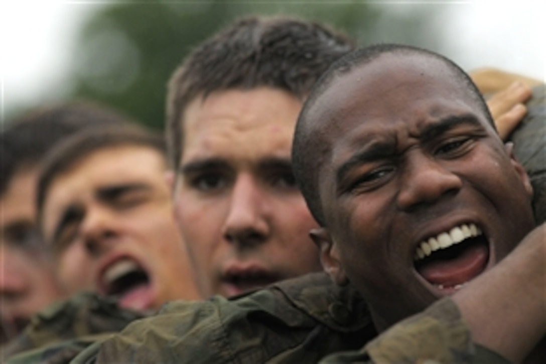 Plebes assigned to the Tigers of Company 11 lift and carry modified telephone poles during the log PT station Sea Trials at the U.S. Naval Academy, Annapolis, Md., May 18, 2010. The Sea Trials event is the capstone training evolution for the Naval Academy freshmen class.