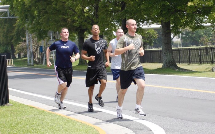 Cpl. Christopher Rogers, armory chief with Combat Logistics Company 36, Pfc. Sir Edward Daniels, small arms technician with CLC-36, Cpl. James Almanza supply clerk with CLC-36, and Lance Cpl. Kevin Robertson, small arms technician with CLC-36, represent the Bums With Guns team as they race to their next station during the Amazing Race here May 21.