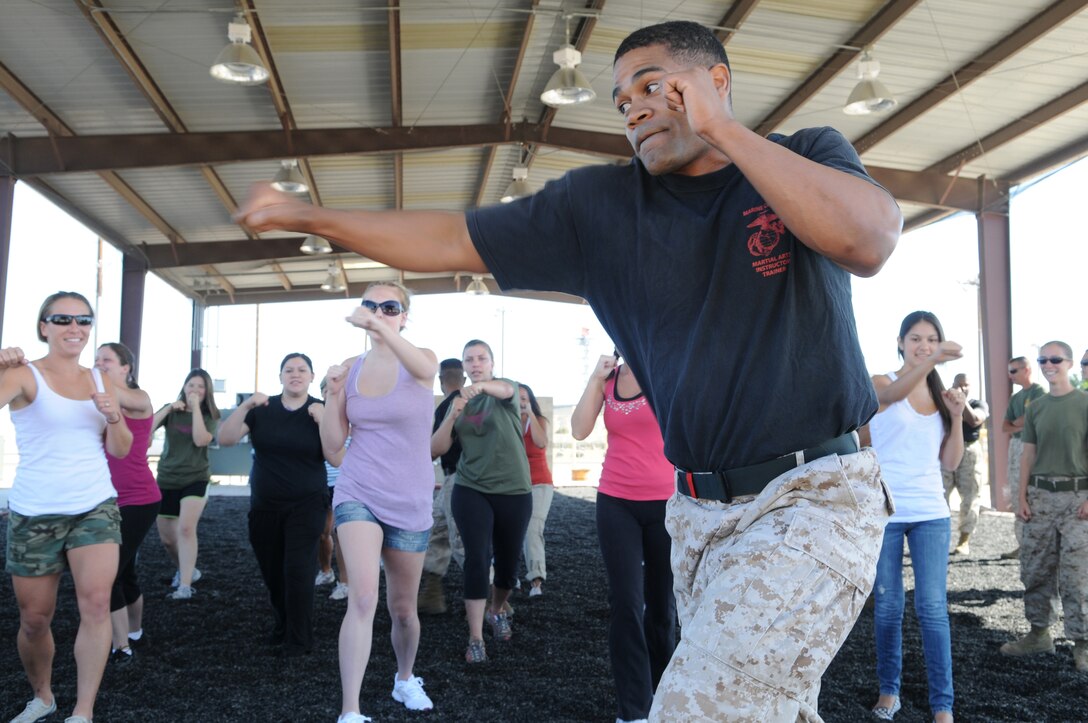 Staff Sgt. Dominique Laboy, Marine Corps martial arts instructor with Combat Logistics Company 36, teaches Marine Attack Squadron 211 spouses some martial arts techniques at the Marine Corps Air Station in Yuma, Ariz., May 21, 2010. More than 20 Avenger spouses spent the day touring the station. “I’ve reached a whole new level of respect for my husband and every other Marine,” said Christina Belanger, squadron spouse.
