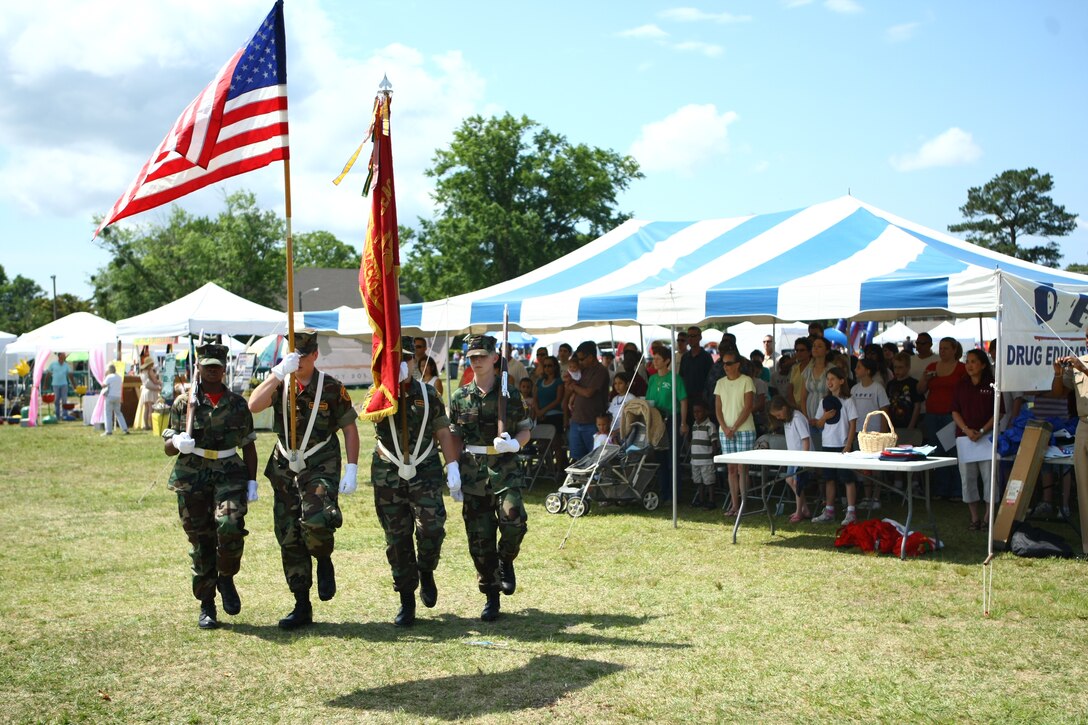 The Young Marines of Jacksonville put on a presentation of the colors at the graduation ceremony of 26 Phase II Drug Education For Youth participants during Maynia on W.P.T. Hill aboard Marine Corps Base Camp Lejeune, May 22.::r::::n::::r::::n::