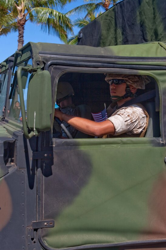 A Marine Corps Base Hawaii, Kaneohe Bay, Marine operates a humvee in the Military Appreciation Day Parade May 22 in Waikiki, Hawaii. This year's Military Appreciation Day, sponsored by USO Hawaii and the city and county of Honolulu, featured musical performances, free admission, food and drinks at the Honolulu Zoo and a parade.