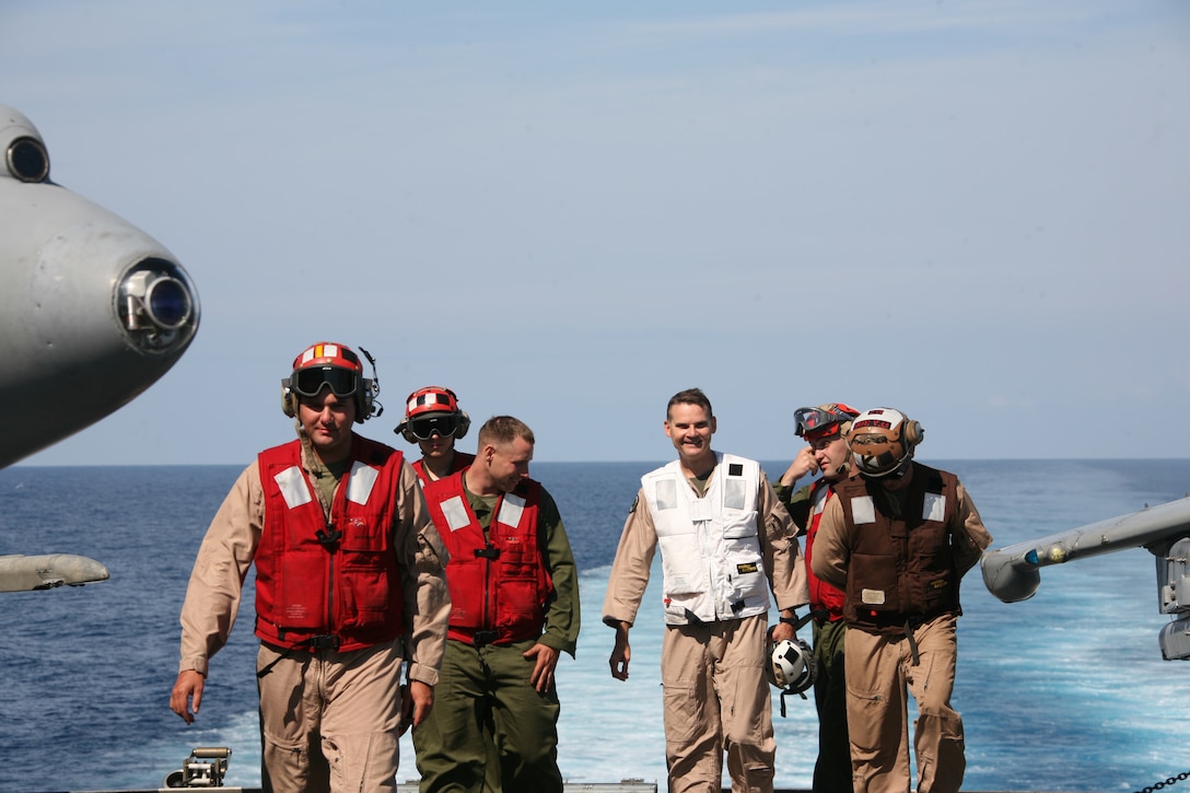 Col. Russell A. Sanborn (White vest), pilot and commanding officer for Marine Aircraft Group 14, converses with his Marines aboard the Ark Royal, the British Royal Navy’s flagship aircraft carrier, May 22. During Exercise Capella Strike, more than 150 MAG-14 Marines and Sailors trained with British counterparts.