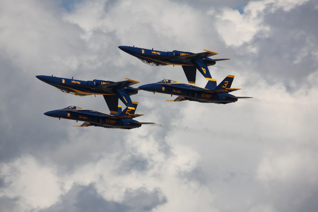 Two Navy Blue Angel F/A-18 Hornets fly inverted as two Hornets fly right-side up during their performance at the 2010 Cherry Point Air Show.