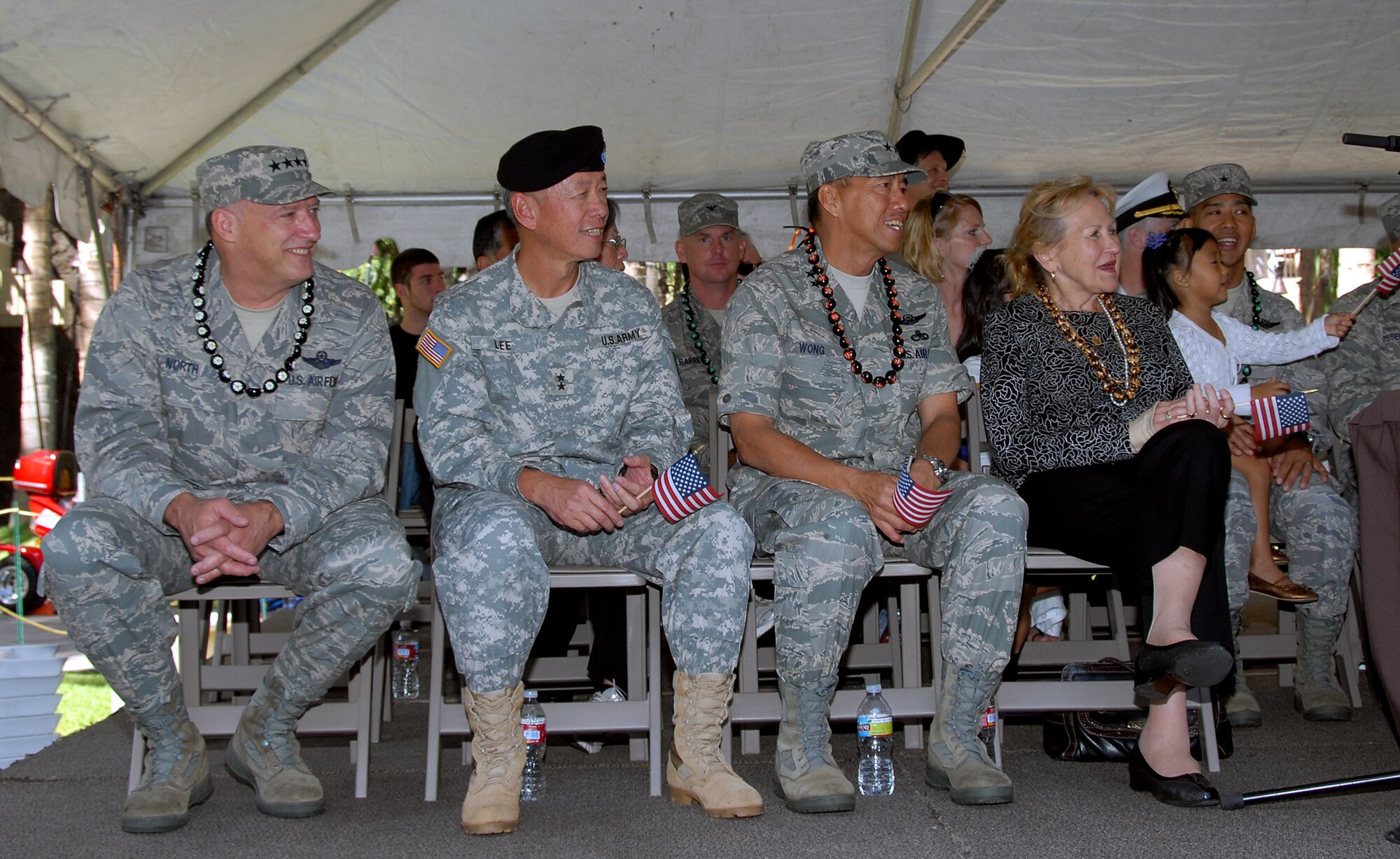 Gen. Gary L. North, PACAF commander, Maj. Gen. Robert G.F. Lee, Hawaii Adjutant General, and Maj. Gen. Darryll D. m. Wong, Hawaii Air National Guard commander, look on as military units march by their pass and review stand during the Salute to our Troops parade in Waikiki, Hawaii, May 22. Military members from all branches of the service were marching as part of the Military Appreciation Month celebration. Joining the current military members in the parade were veterans from WWII, and the Korean and Vietnam wars. (U.S. photo/Tech. Sgt. Betty J. Squatrito-Martin)