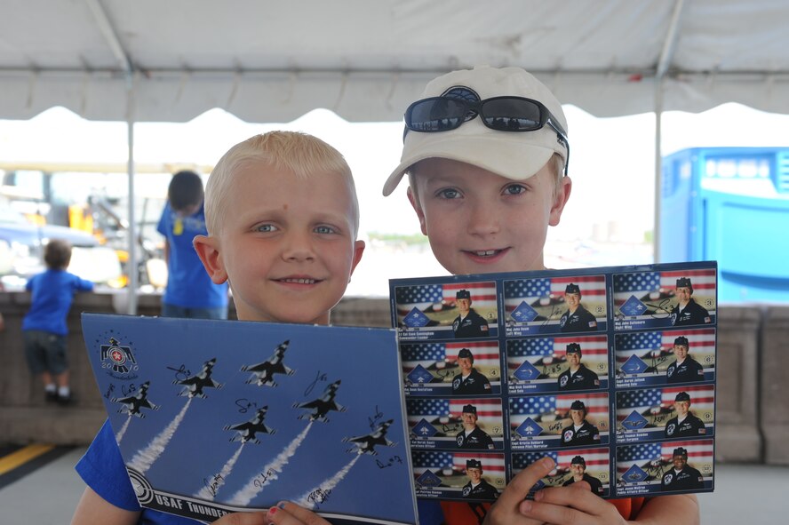 Jordan and Brady Dvorak (from left to right) hold up their autographed United States Air Force Thunderbird cards after meeting the Thunderbird pilots during Make-A-Wish Day at Grand Forks Air Force Base May 21. The Make-A-Wish foundation of North Dakota provides opportunities for children with life-threatening medical conditions to help the human experience with hope, strength and joy. (U.S. Air Force photo by Airman 1st Class Amber Price)