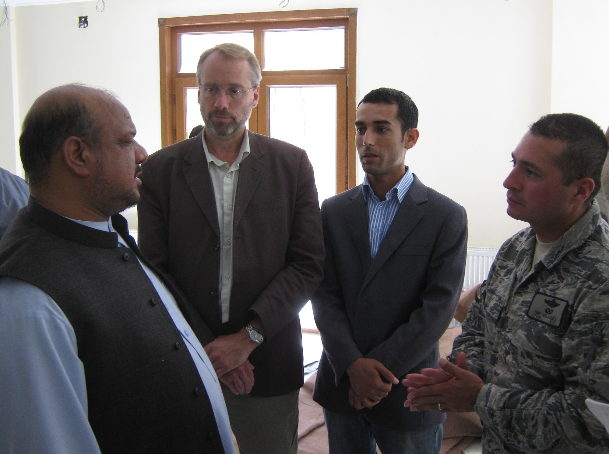 PANJSHIR PROVINCE, Afghanistan ? (left to right) Mohammad ?Marshal? Qasim Fahim, Afghanistan First Vice President, James DeHart, U.S. Department of State and Provincial Reconstruction Team Panjshir director, Khalid Siddiqi, PRT Panjshir political advisor, and U.S. Air Force Lt. Col. Curtis Velasquez, PRT Panjshir commander, talk during a May 20 meeting at Fahim?s home in the Khenj District. (Photo by U.S. Air Force 2nd Lt. Jason Smith, Provincial Reconstruction Team Panjshir Public Affairs) 