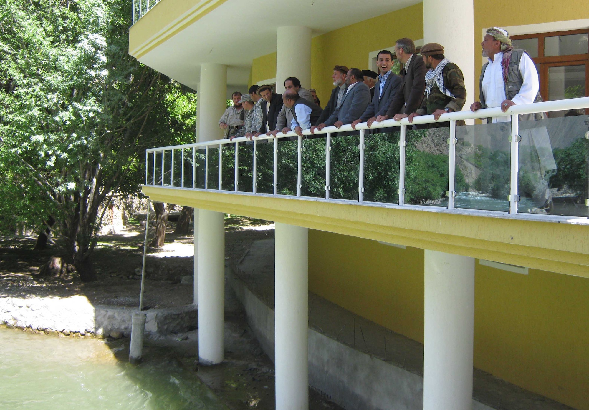 PANJSHIR PROVINCE, Afghanistan ? Mohammad ?Marshal? Qasim Fahim, Afghanistan First Vice President, members of Provincial Reconstruction Team Panjshir, Keramuddin Keram, Panjshir governor, Abdul Rahman Kabiri, Panjshir deputy governor, and other guest look over the balcony at Fahim?s home in the Khenj District. Fahim hosted the group for a meeting and lunch May 20. (Photo by U.S. Air Force 2nd Lt. Jason Smith, Provincial Reconstruction Team Panjshir Public Affairs
