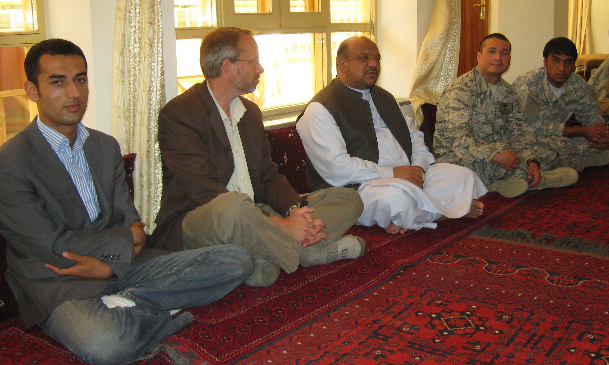 PANJSHIR PROVINCE, Afghanistan ? (left to right) Khalid Siddiqi, Provincial Reconstruction Team Panjshir political advisor, James DeHart, U.S. Department of State and PRT Panjshir director, Mohammad ?Marshal? Qasim Fahim, Afghanistan First Vice President, U.S. Air Force Lt. Col. Curtis Velasquez, PRT Panjshir commander, and Abdul Qader Ahmadi, PRT Panjshir interpreter, talk during a May 20 meeting at Fahim?s home in the Panjshir Province. (Photo by U.S. Air Force 2nd Lt. Jason Smith, Provincial Reconstruction Team Panjshir Public Affairs) 
