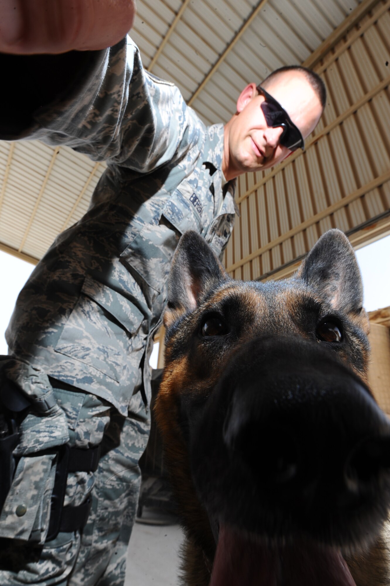 Staff Sgt. Jonathan Bierbach, 379th Expeditionary Security Forces Squadron military working dog handler, and Deni, 379 ESFS military working dog, perform a random anti-terrorism measure inspection at a non-disclosed Southwest Asia location April 9, 2010. (U.S. Air Force photo by Senior Airman Kasey Zickmund)[RELEASED]