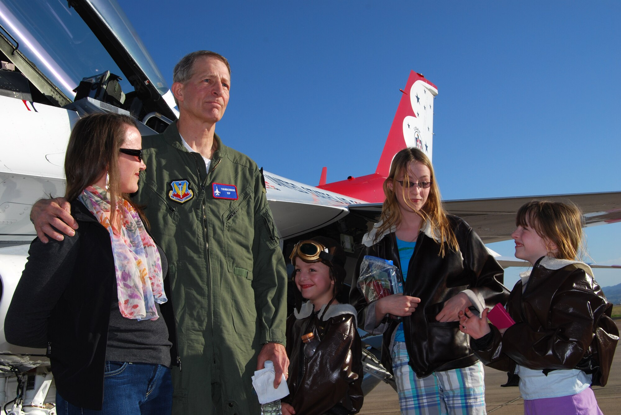 Dr. David Benke talks to pilots and aircrew with the Thunderbirds U.S. Air Force Air Demonstration Squadron at Peterson Air Force Base, Colo., after riding on a "Hometown Hero" incentive flight with Thunderbirds No. 7 pilot Lt. Col. Derek Routt May 23, 2010. Pictured with Dr. Benke are his wife, Sandra, and his children, Alec (age 8), Marissa (age 13) and Amanda (age 8). (U.S. Air Force photo/Staff Sgt. Don Branum)