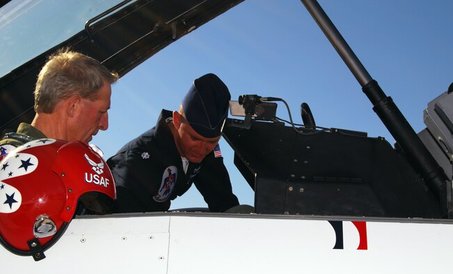 Lt. Col. Derek Routt helps Dr. David Benke familiarize himself with the cockpit of the No. 7 Thunderbirds jet, an F-16 Fighting Falcon, on the flightline at Peterson Air Force Base, Colo., May 23, 2010. Colonel Routt flew Dr. Benke on a "Hometown Hero" incentive flight as a gesture of gratitude for Dr. Benke's actions taking down an active shooter at Deer Creek Middle School in Littleton, Colo., in February. The Thunderbirds are the U.S. Air Force Air Demonstration Squadron, based at Nellis AFB, Nev. (U.S. Air Force photo/Staff Sgt. Don Branum)