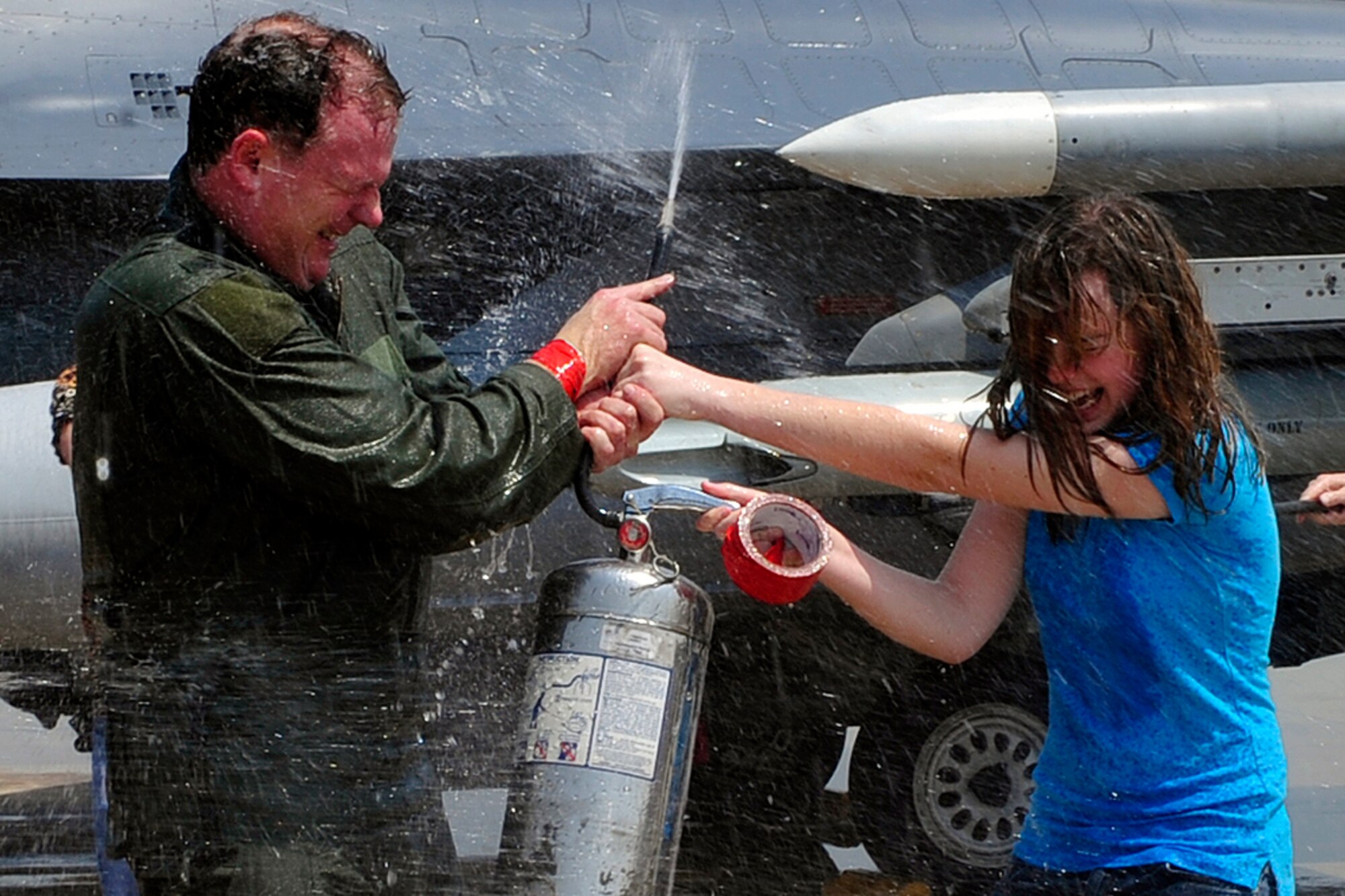 Col. Mark Mattison, 51st Fighter Wing vice commander, sprays his daughter, Sarah, during his "fini-flight" celebration at Osan Air Base, Republic of Korea, May 21. He has served as the wing's vice commander since June 2008. Colonel Mattison and his family are heading to Ramstein AB, Germany, where he will serve as Headquarters U.S. Air Forces in Europe director of staff. (U.S. Air Force photo/Staff Sgt. Eunique Stevens)