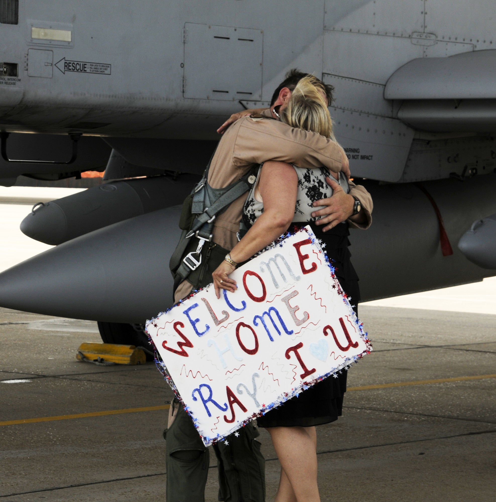 Lt. Col. Ray Hunter, an A-10C Thunderbolt II "Warthog" pilot with the Arkansas Air National Guard's 188th Fighter Wing, reunites with his wife May 22 following an Aerospace Expeditionary Force (AEF) deployment to Kandahar Airfield in Afghanistan.  Hunter served as the 184th Expeditionary Squadron commander while deployed to Kandahar. (U.S. Air Force photo by Capt. Heath Allen/Arkansas National Guard Public Affairs)