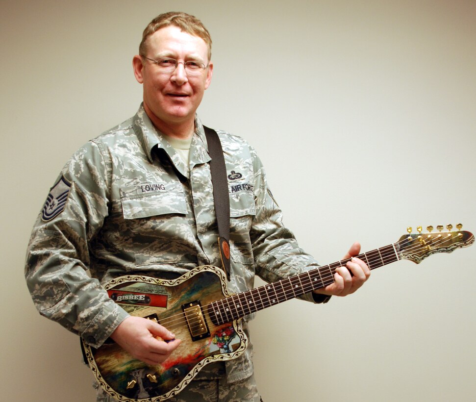 Master Sgt. Tony Loving of the 932nd Airlift Wing, plays a song on the electric guitar he hand-crafted, which took several months to complete.  (U.S. Air Force photo/Tech. Sgt. Dan Oliver)