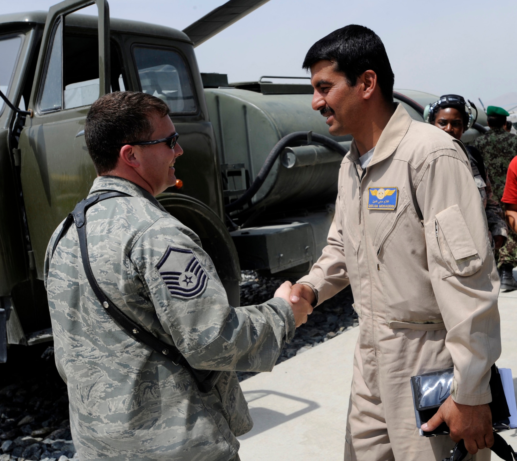 Master Sgt. Raymond Rogers, 440th Air Expeditionary Advisory Squadron armament and ammunition flight advisor, greets Capt. Gholam Mohaiudin, Afghanistan National Army Air Corps Mi-35 Hind E helicopter pilot, prior to a training mission May 15, 2010, at Kabul International Airport, Aghanistan.  Sergeant Rogers spent a year supporting the Combined Air Power Transition Force effort of building a professional air force for Afghanistan. His experience has been richly rewarding. (U.S. Air Force photo/Tech. Sgt. Oshawn Jefferson, released)