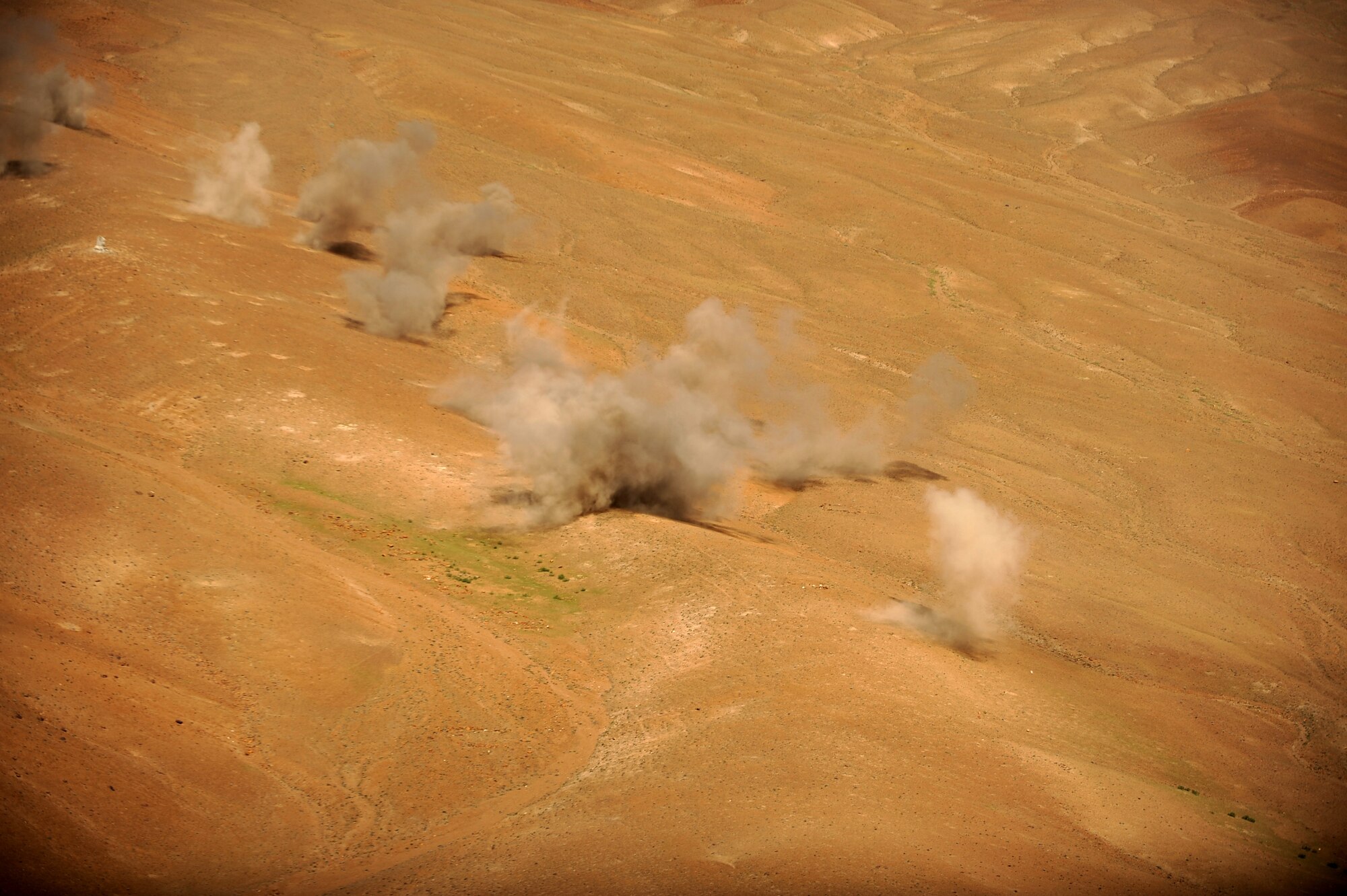 Dust rises from the impact points of KP long-guided rockets shot from an Afghan National Army Air Corps Mi-35 helicopter during a live-fire mission, May 11, 2010, over the Forward Operating Base Shank, Afghanistan, firing range. (U.S. Air Force photo/ Staff Sgt. Manuel J. Martinez, released)