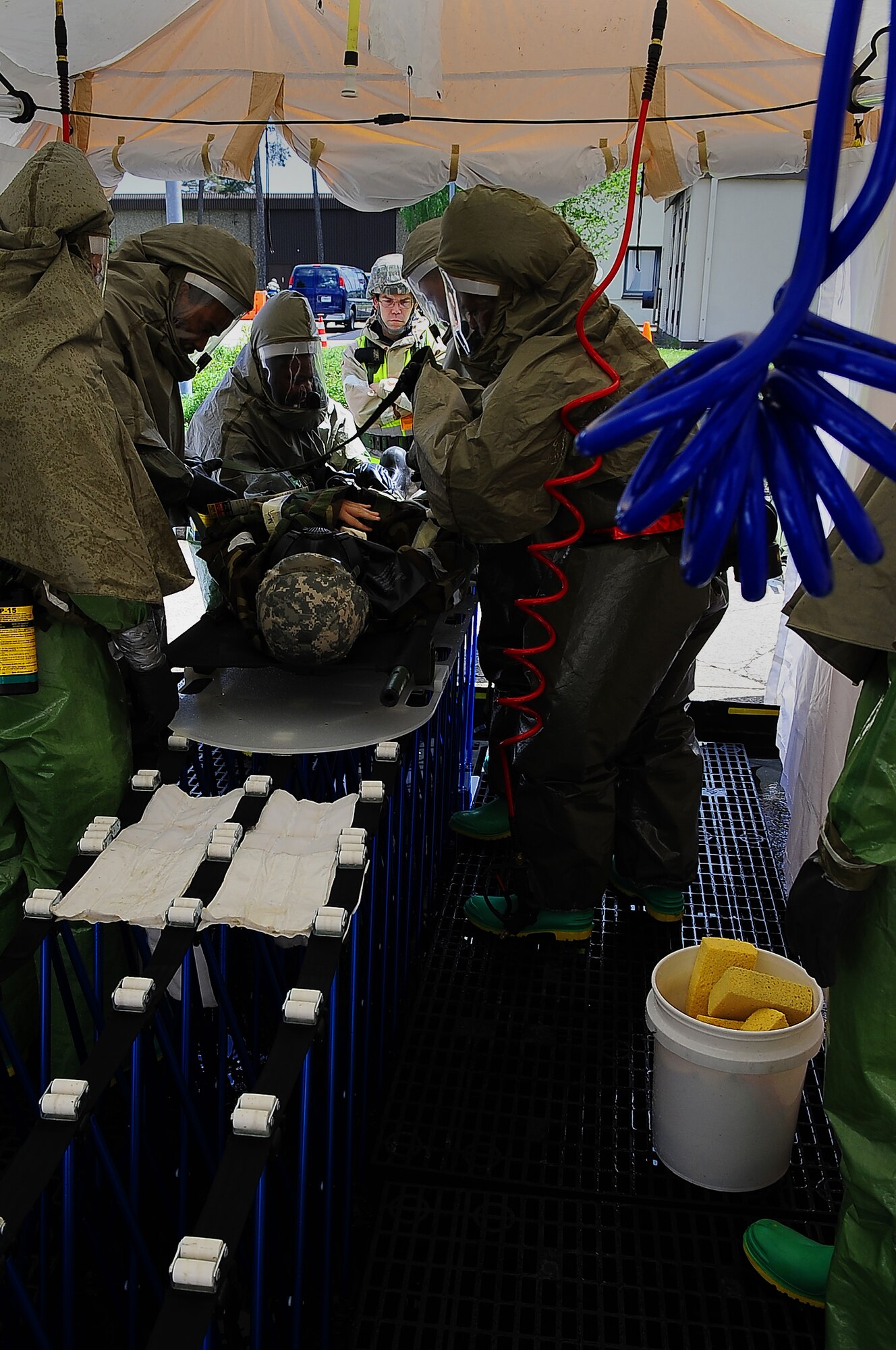 U.S. Air Force members of the 86th Medical Group personnel decontamination team simulate decontaminating a 'victim' during an operational readiness excercise, Ramstein Air Base, Germany, May 23, 2010. The exercise is being conducted to prepare for an up-coming operational readiness inspection. (U.S. Air Force photo by Senior Airmen Tony R. Ritter) 